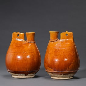 A pair of Chinese Liao Dynasty yellow-glazed leather flasks