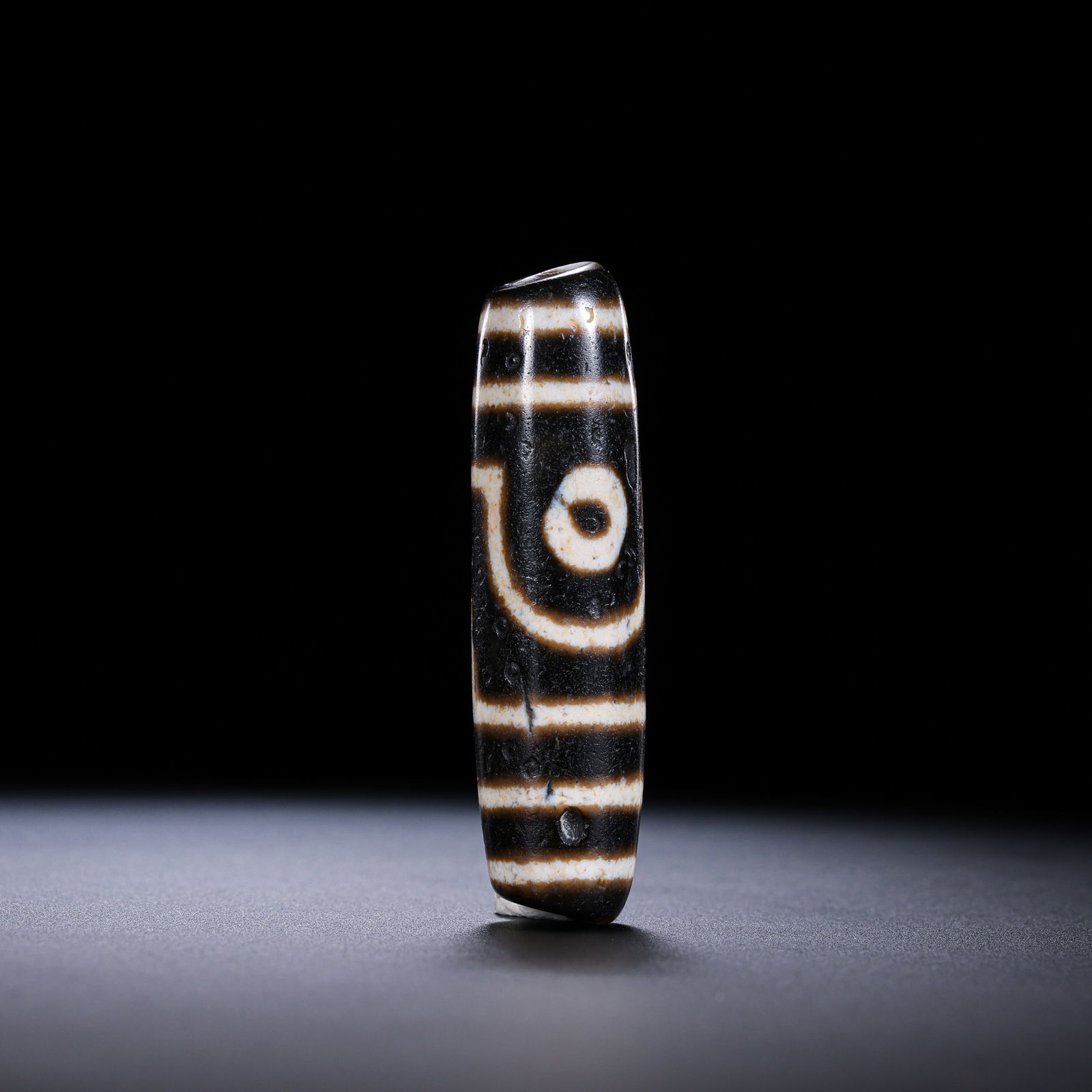 A RARE AND MAGNIFICENT 'TWO-EYED' DZI BEADHIMALAYAN REGION, TIBET, ANCIENT TO MEDIEVAL PERIOD (1 of 9)