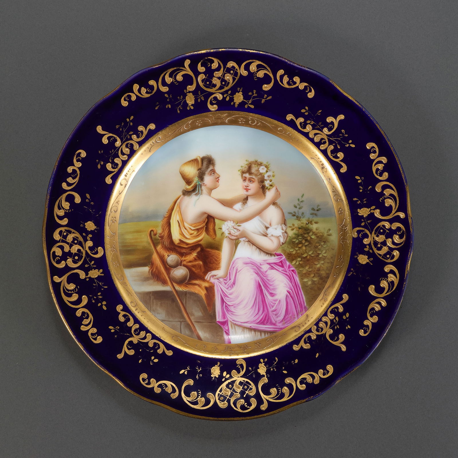 RARE 'SÈVRES-STYLE' COBALT BLUE AND GILT CABINET PLATEPROBABLY FRENCH OR GERMAN, CIRCA 1890–1920: Description This finely executed porcelain cabinet plate is a superb example of European Neoclassical revival artistry. It features a rich "Bleu Nouveau" (Cobalt Blue) ground, serving as a regal frame