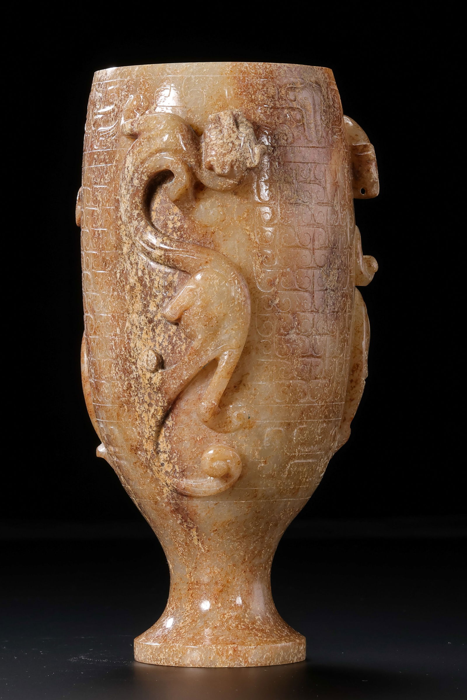 AN IMPORTANT AND MAGNIFICENT WHITE JADE CUP WITH THREE HIGH-RELIEF 'CHILONG' DRAGONSHAN DYNASTY (202: Description This monumental jade cup is carved from a substantial and exceptionally fine block of Hetian white jade, possessing a translucent, warm luster with areas of faint russet skin (often referr
