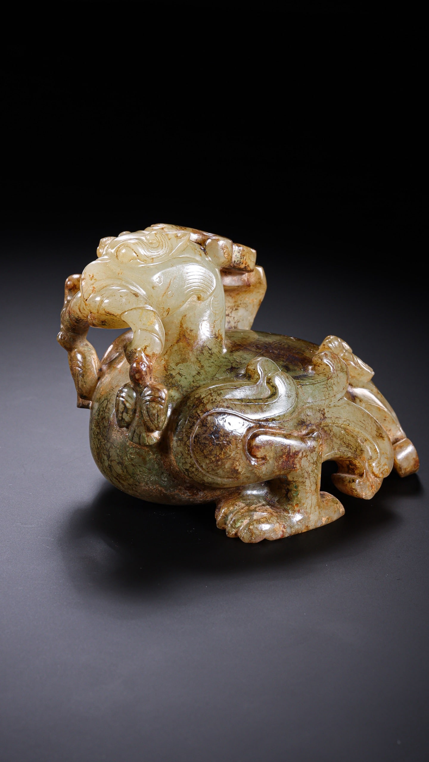 A RARE AND MAGNIFICENT WHITE JADE CARVING OF A 'XUAN-NIAO' (MYTHICAL BIRD) AND FLEDGLING WARRING: Description This extraordinary jade carving is a tour de force of late Warring States lapidary art. Carved from a substantial and exceptionally fine block of Hotan white jade, the sculpture depicts th