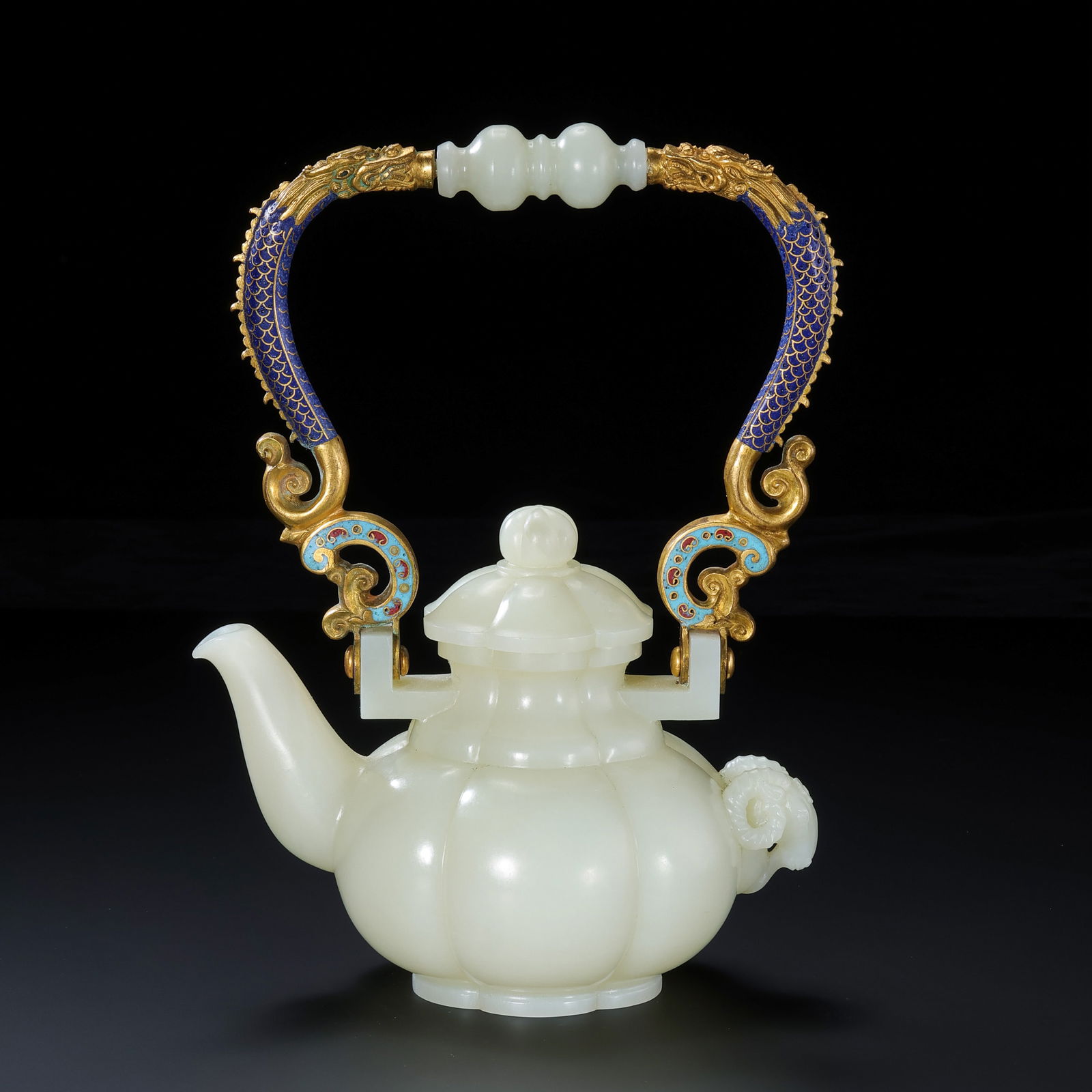MAGNIFICENT AND RARE IMPERIAL WHITE JADE 'MELON-SECTION' TEAPOT WITH CLOISONNÉ ENAMEL DRAGON: Description This extraordinary teapot is a masterpiece of Imperial lapidary and enamel craftsmanship, embodying the opulent aesthetic of the Qianlong Emperor’s court. The vessel is masterfully carve