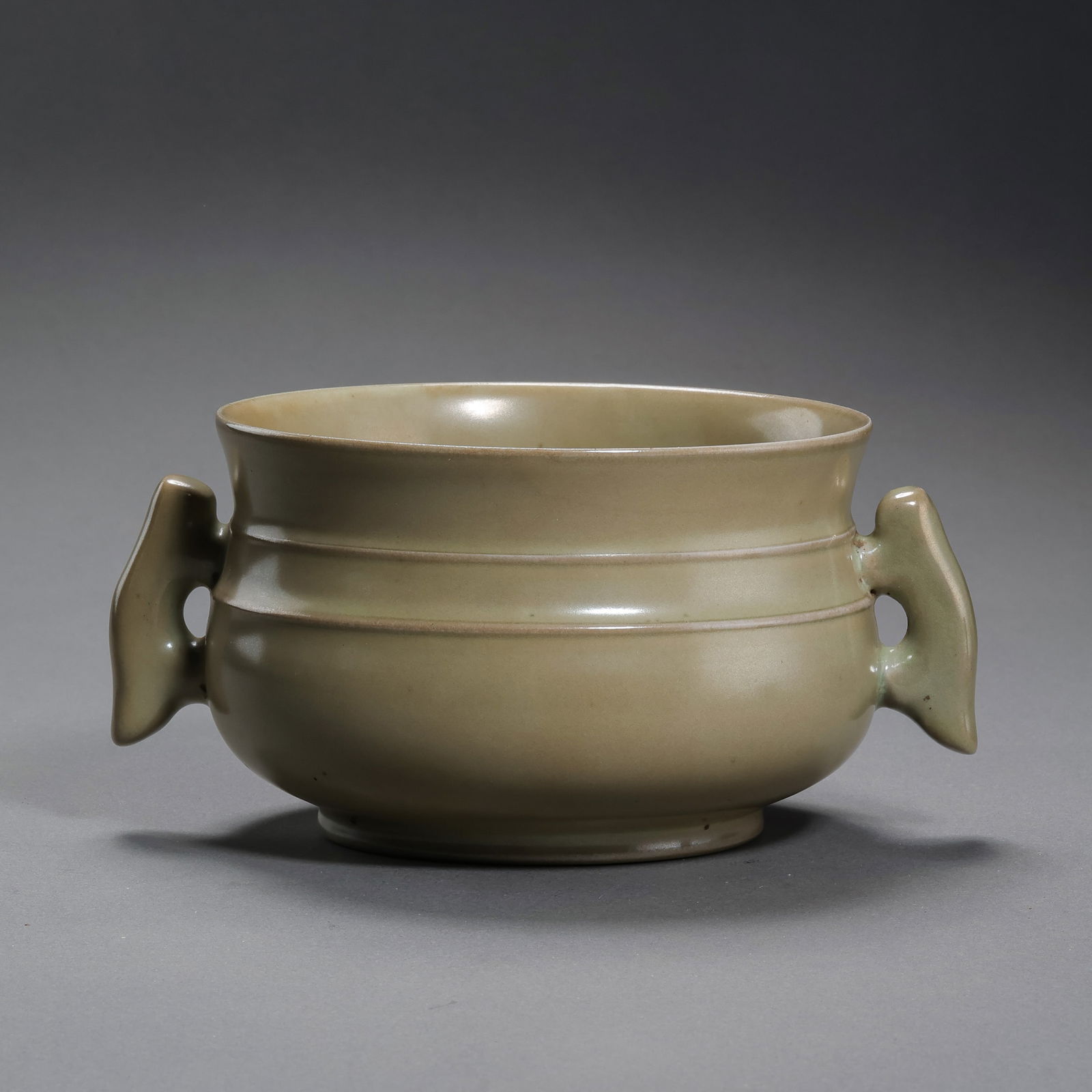 A MAGNIFICENT AND EXCEEDINGLY RARE 'RU' CELADON RIBBED CENSERNORTHERN SONG DYNASTY (960–1127): Description This exceptional censer is of a sturdy cylindrical form, rising from a thickly potted ring foot (quan-zu) to a slightly flared rim. The exterior is punctuated by three horizontal raised 's