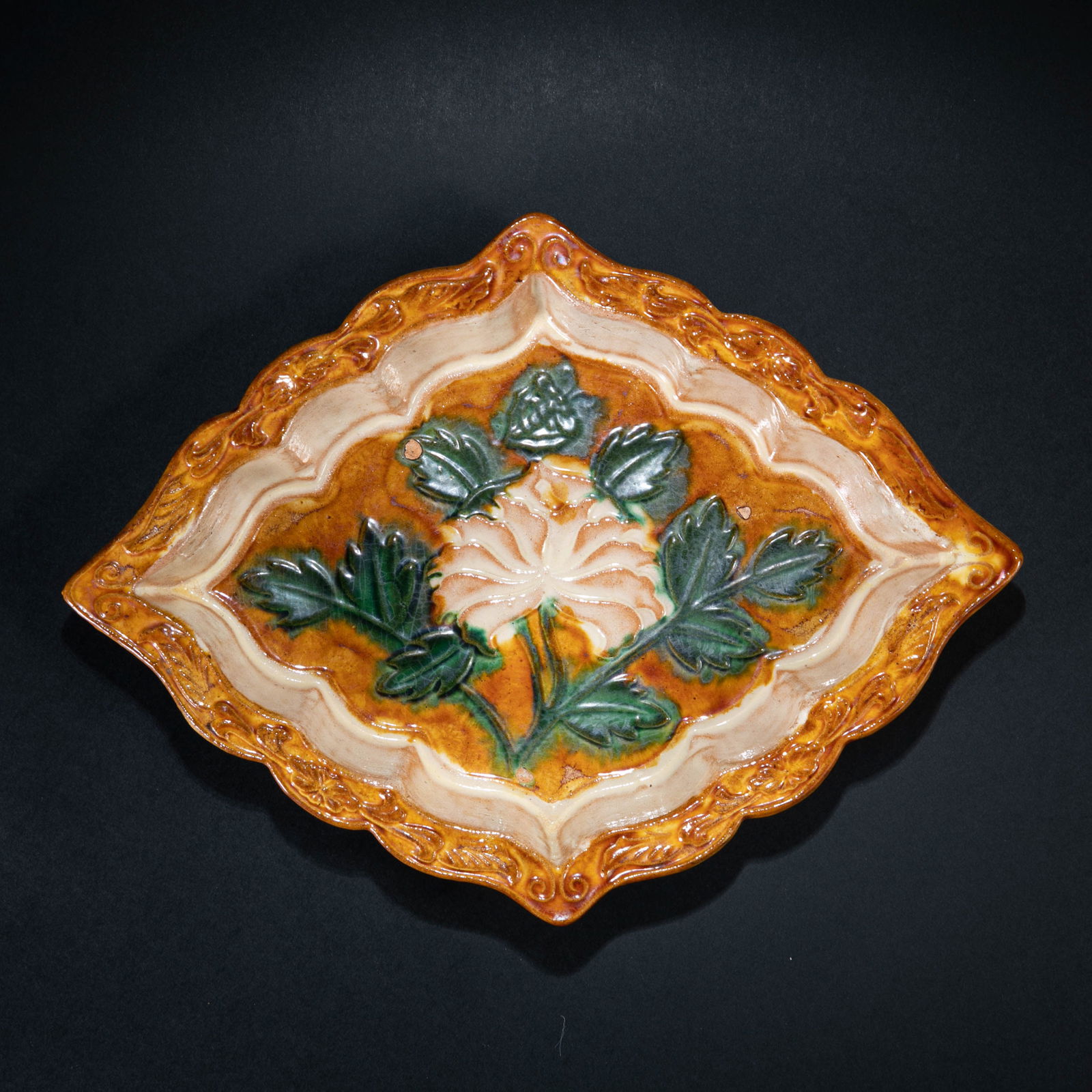 A RARE AND MAGNIFICENT SANCAI-GLAZED SQUARE DISHLIAO - JIN DYNASTY, 11TH - 13TH CENTURY: Description The dish is of rare square form, sturdily potted with flaring sides rising from a flat base to a broad, flat rim. The interior is masterfully decorated with a central medallion featuring a