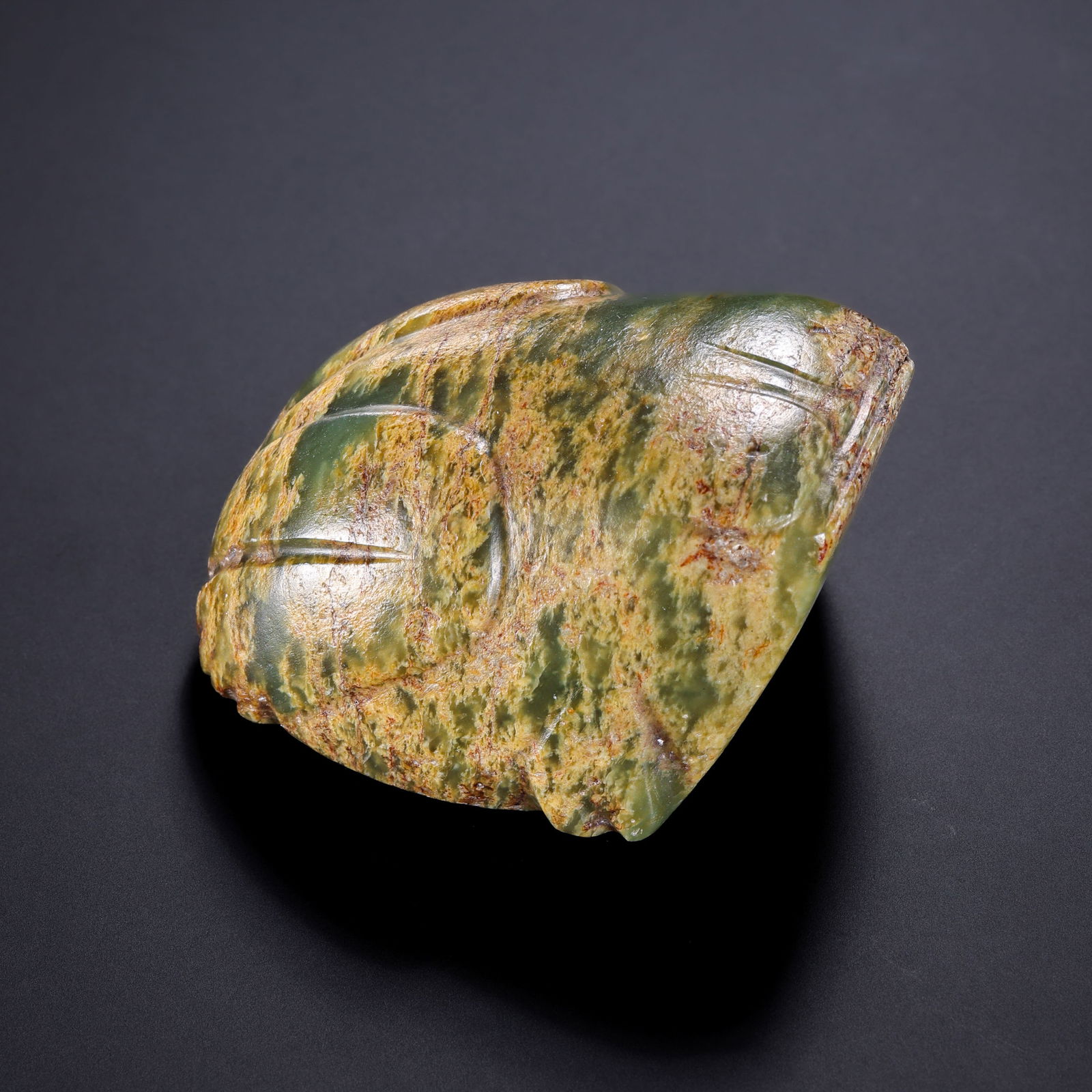 A RARE AND IMPORTANT CELADON JADE FIGURE OF A FROGNEOLITHIC PERIOD, HONGSHAN CULTURE (C. 3500–2500: Description This exceptional and rare jade carving is fashioned from a substantial block of celadon nephrite jade (qing-yu), possessing a semi-translucent quality and a rich, waxy luster. The stone ex