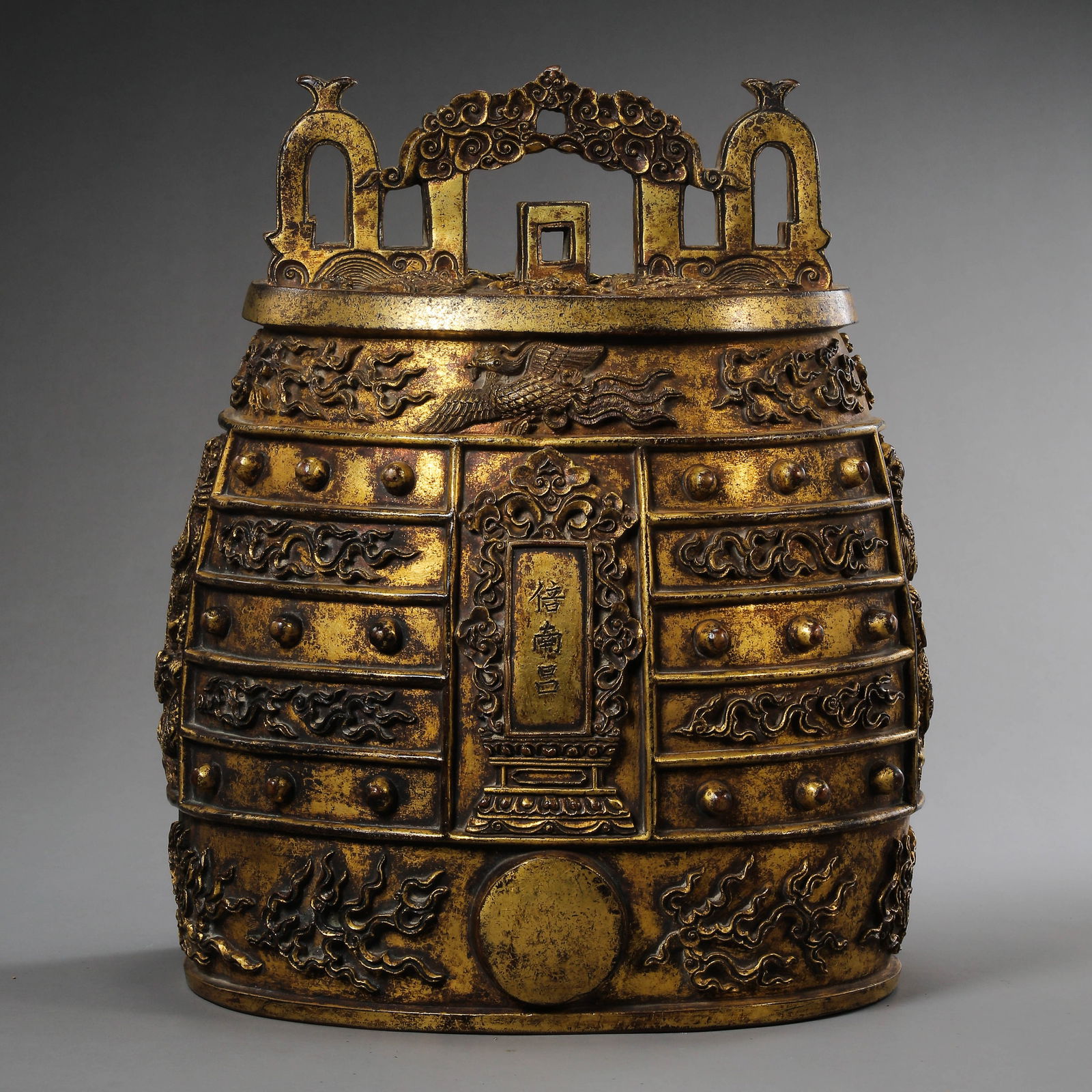 A RARE AND MASSIVE GILT-BRONZE RITUAL MUSICAL BELL,BIANZHONGQING DYNASTY 17TH - 18TH CENTURY: Description The bell is of a massive, flattened oval section, expertly cast with thick, robust walls designed to produce a profound, resonating ritual tone. The exterior is richly fire-gilded to a dee