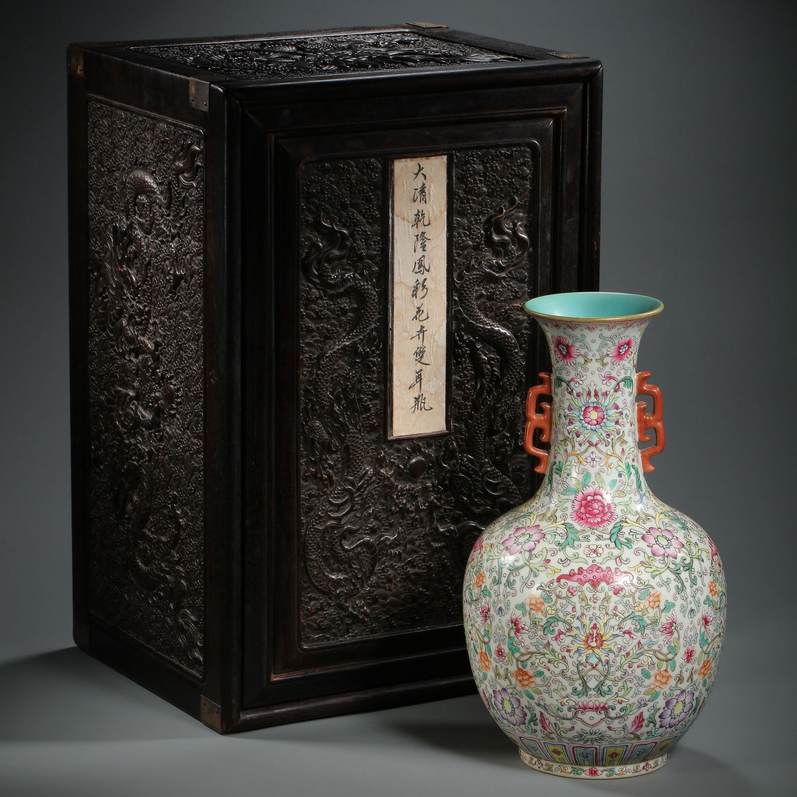 RARE AND MAGNIFICENT 'WUCAI' FLORAL 'SHANGPING' VASEMARK AND PERIOD OF QIANLONG (1736-1795): DescriptionThe vase is elegantly potted with a globular body rising to a tall, slightly flared neck, flanked by a pair of delicate Ruyi-shaped handles. The exterior is vibrantly decorated in the Wucai