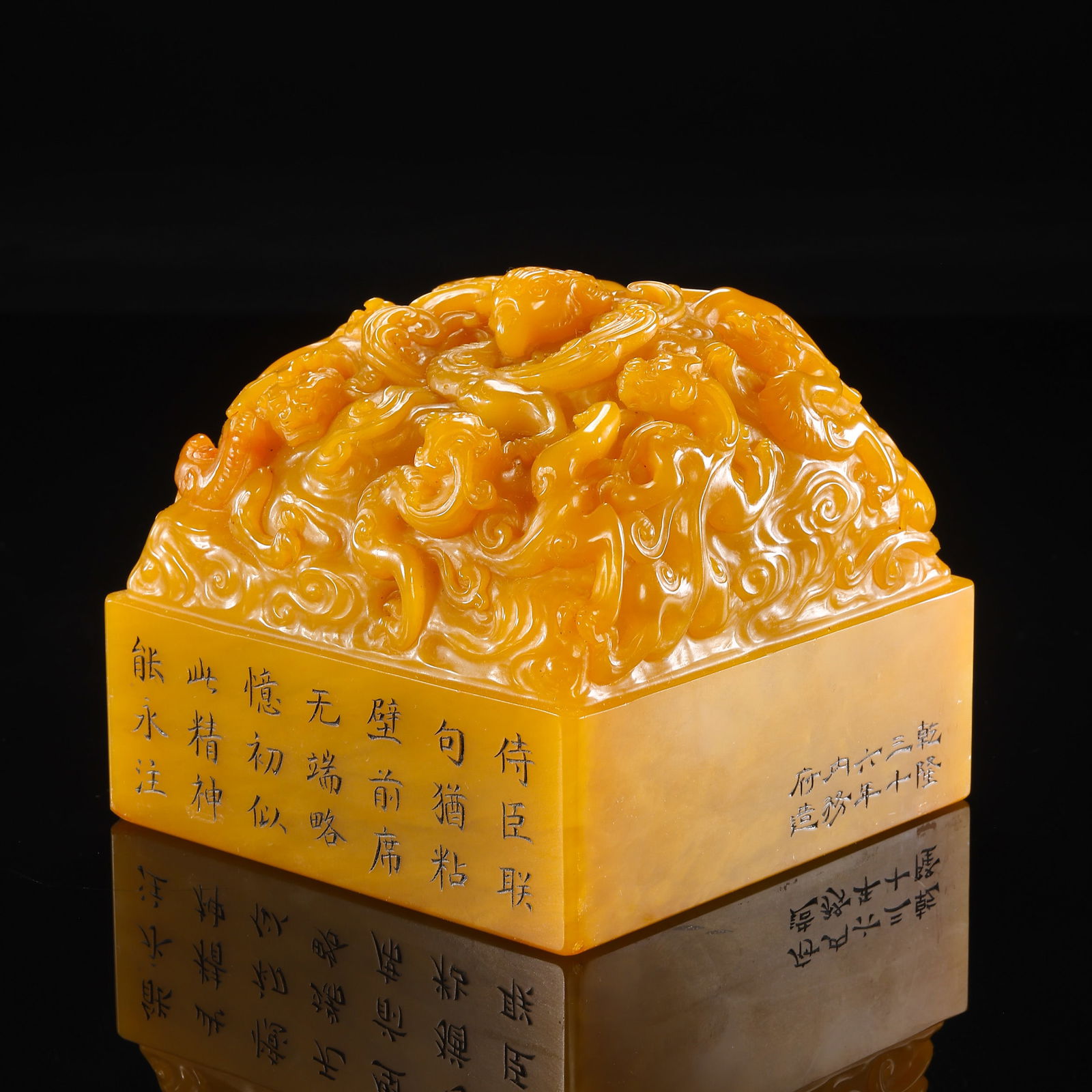 A HIGHLY IMPORTANT AND MONUMENTAL IMPERIAL TIANHUANG STONE 'PHOENIX AND CHILONG' SEALMARK AND PERIOD: Description This monumental seal is an extraordinary testament to the opulence of the Qianlong reign. Carved from a massive and exceptionally rare block of Tianhuang (Field-Yellow) stone, the seal is