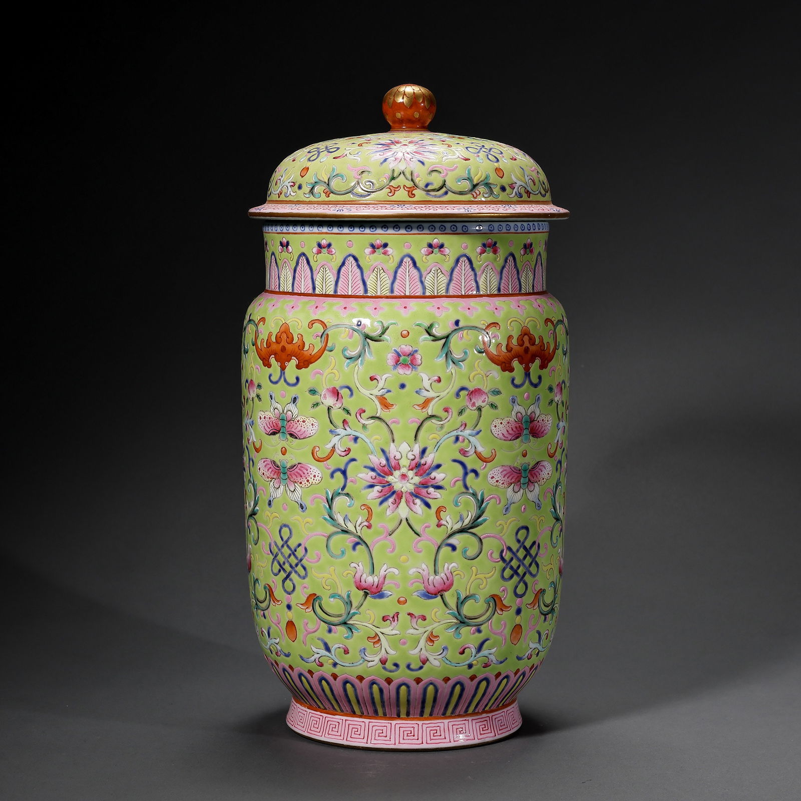 A FINE AND RARE LIME-GREEN GROUND FAMILLE ROSE 'ZHUANG' JARMARK AND PERIOD OF JIAQING (1796–1820): Description This magnificent 'Zhuang' jar is an outstanding example of the opulence characterizing Imperial porcelain from the Jiaqing reign. The vessel features a stout, cylindrical body supported by