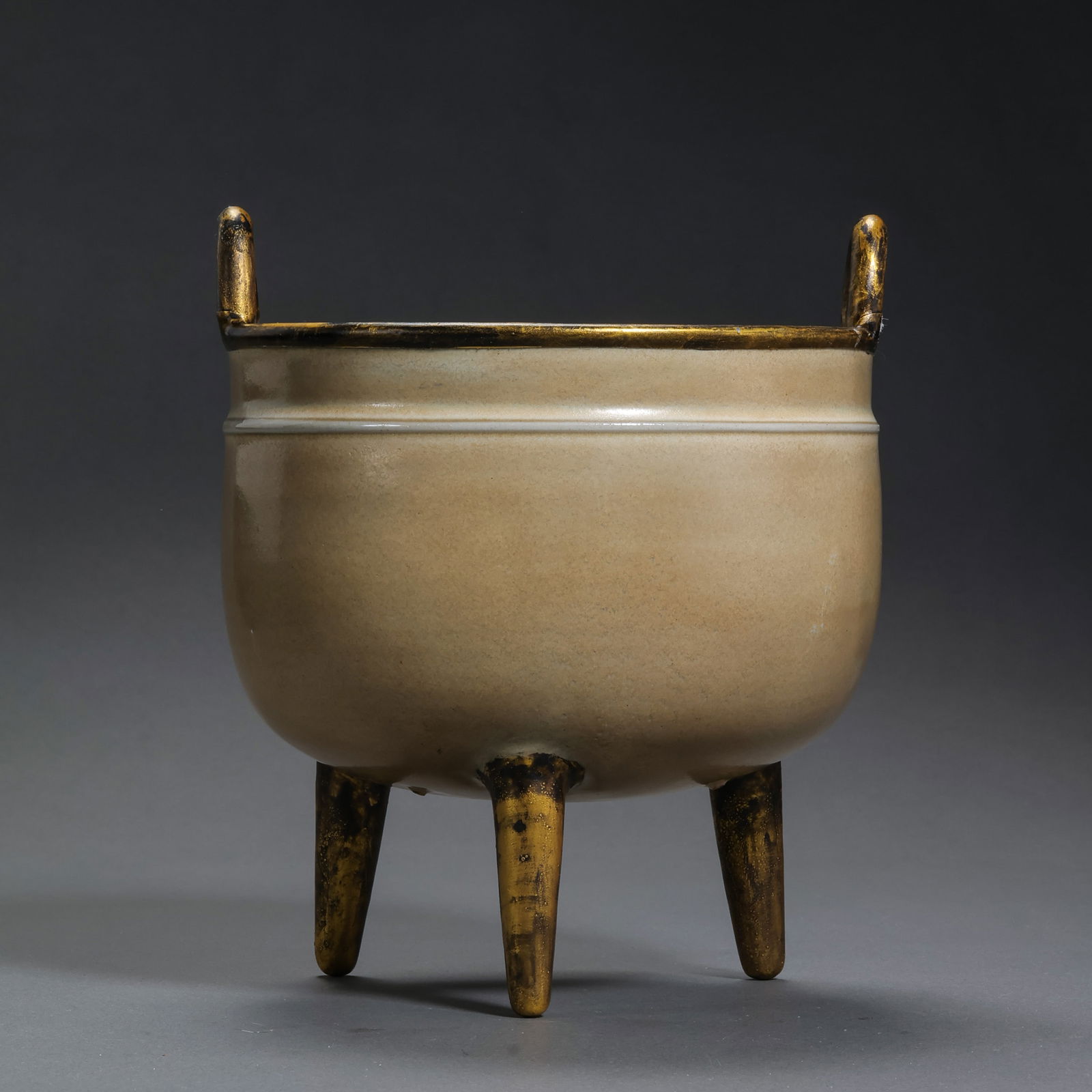 A MAGNIFICENT AND EXCEEDINGLY RARE METAL-BOUND 'RU' CELADON TRIPOD CENSERNORTHERN SONG DYNASTY: Description This monumental censer is masterfully potted in the form of an archaic bronze 'Ding', featuring a compressed globular body supported by three sturdy, slightly flared feet. The shoulder is
