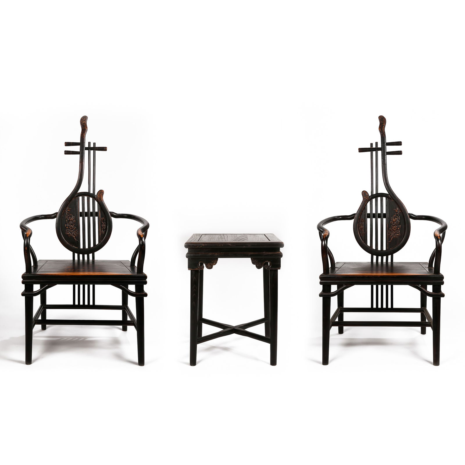 A SUITE OF CHINESE 'HONGMU' FURNITURELATE QING DYNASTY - REPUBLIC PERIOD: The suite comprising a pair of intricately carved armchairs and a matching circular stand. Each armchair is constructed with a high rectangular backrest and openwork scrolled armrests. The circular st