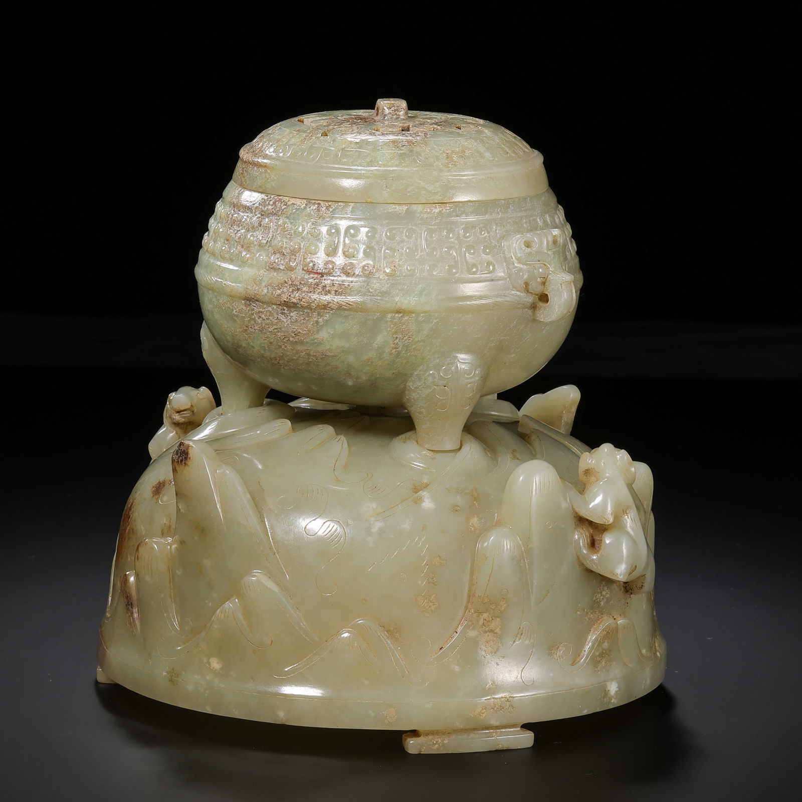 A RARE AND MAGNIFICENT TWO-PIECE NEPHRITE JADE TRIPOD CENSER AND 'BEARS' STANDMING DYNASTY OR: Description This exceptional two-part set is a masterpiece of lapidary art, meticulously carved from substantial blocks of Hetian jade. The set consists of a classic tripod censer and an intricately s