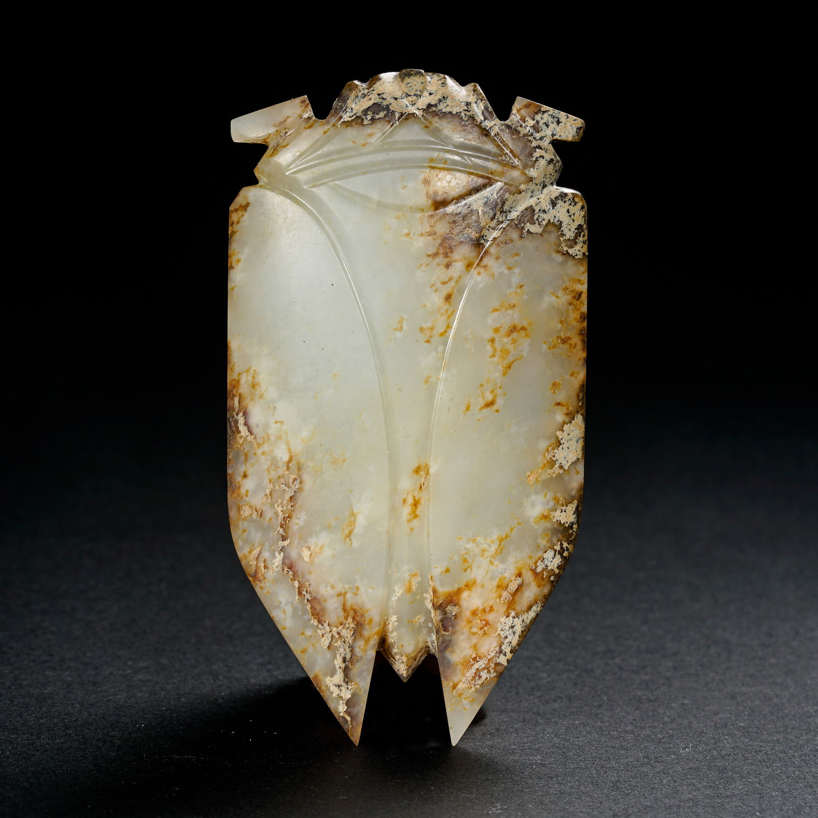 AN EXCEPTIONALLY RARE AND IMPORTANT WHITE JADE 'CICADA' WITH GOLD INLAYS AND INSCRIPTIONSHAN DYNASTY: The cicada is masterfully carved from an unctuous, pale celadon-white Hetian jade with a subtle waxy luster. It is rendered in the celebrated "Han Ba Dao" (Eight Strokes of Han) style, featuring clean