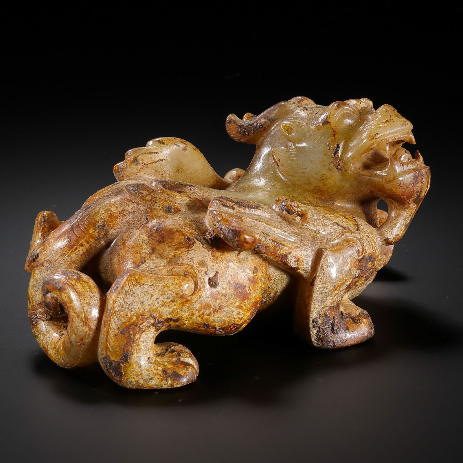 A MONUMENTAL AND POWERFULLY CARVED WHITE JADE WINGED MYTHICAL BEAST,BIXIEWARRING STATES PERIOD: Description This extraordinary sculpture is masterfully carved in the round from a single, substantial block of Hetian white jade. The stone possesses a creamy, translucent quality, now enriched by a