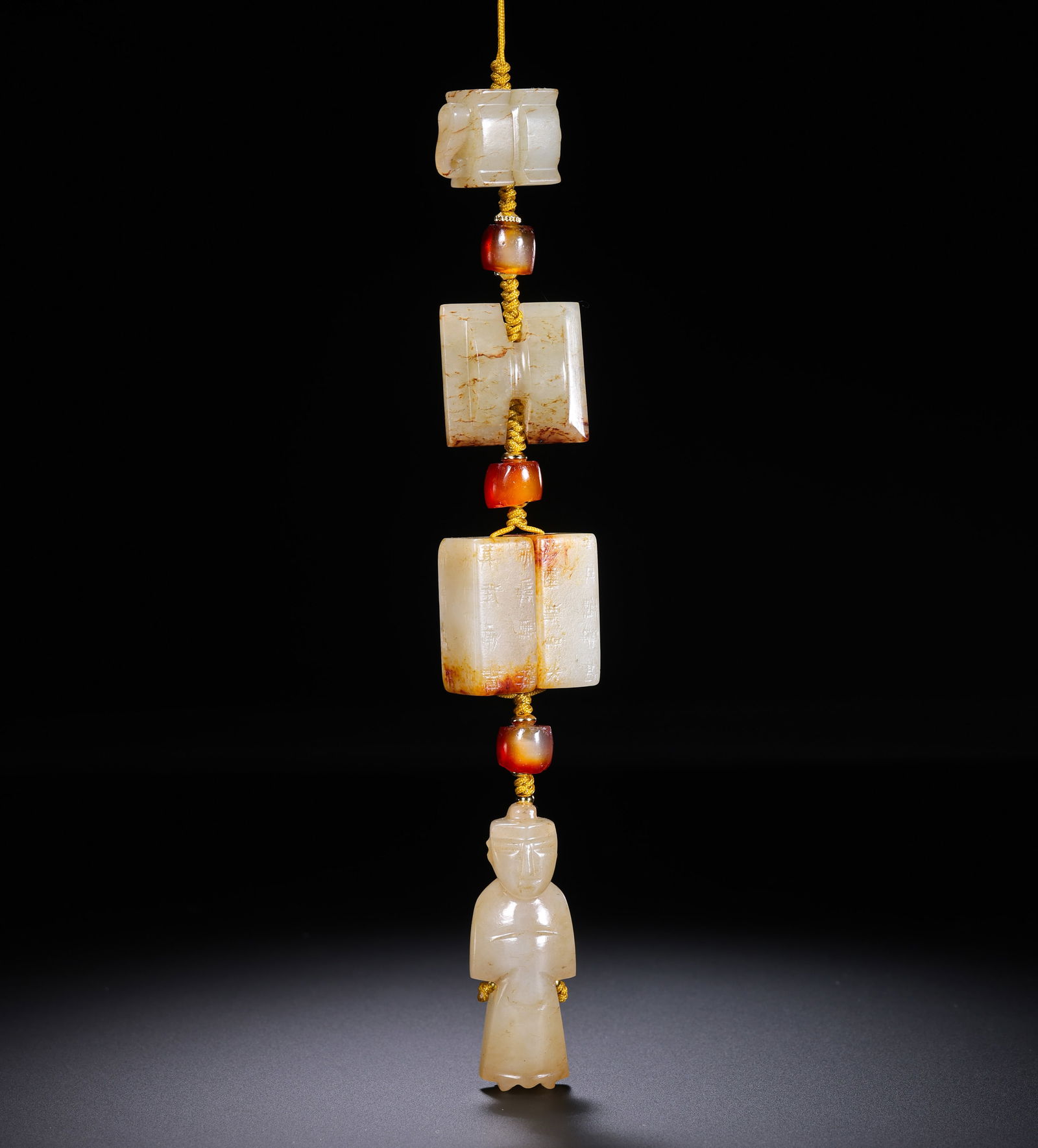 A RARE SET OF THREE WHITE JADE APOTROPAIC PENDANTS:SINAN ,GANGMAO , ANDWENGZHONGHAN DYNASTY OR LATER: Description This rare and complete ensemble consists of three meticulously carved white jade pendants, each serving a distinct protective function in ancient Chinese cosmology. The jade is of a warm,