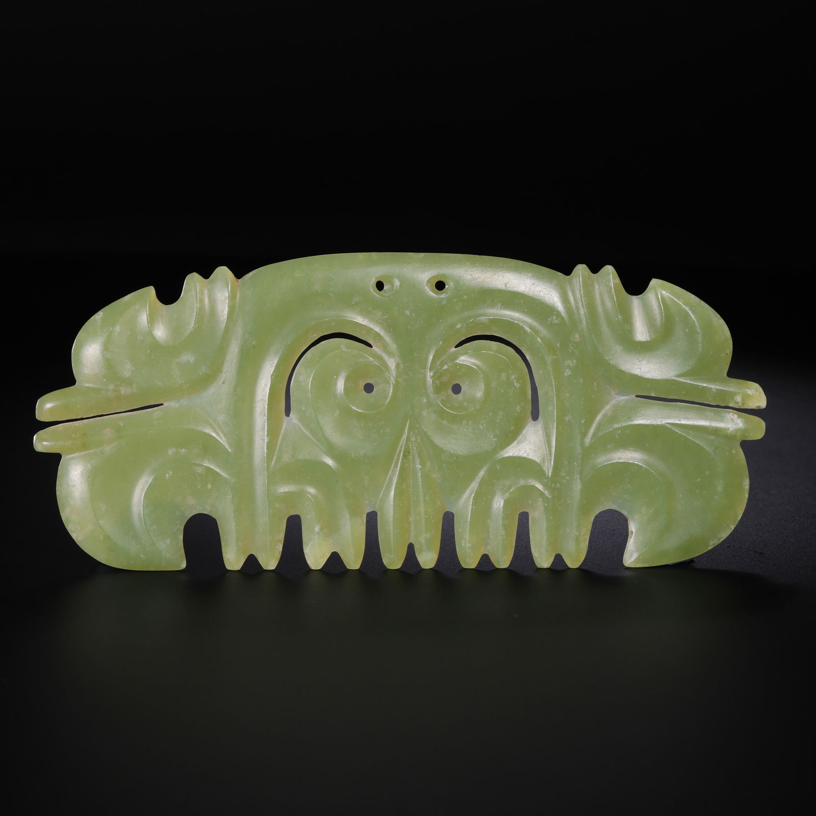 A RARE AND IMPORTANT YELLOWISH-CELADON JADE 'CLOUD-SHAPED' ORNAMENT,GOUYUNPEINEOLITHIC PERIOD,: The ceremonial ornament is masterfully carved from an attractive yellowish-celadon jade, exhibiting a flattened, rectangular form with elegantly curved, silhouetted edges. The central section is decor