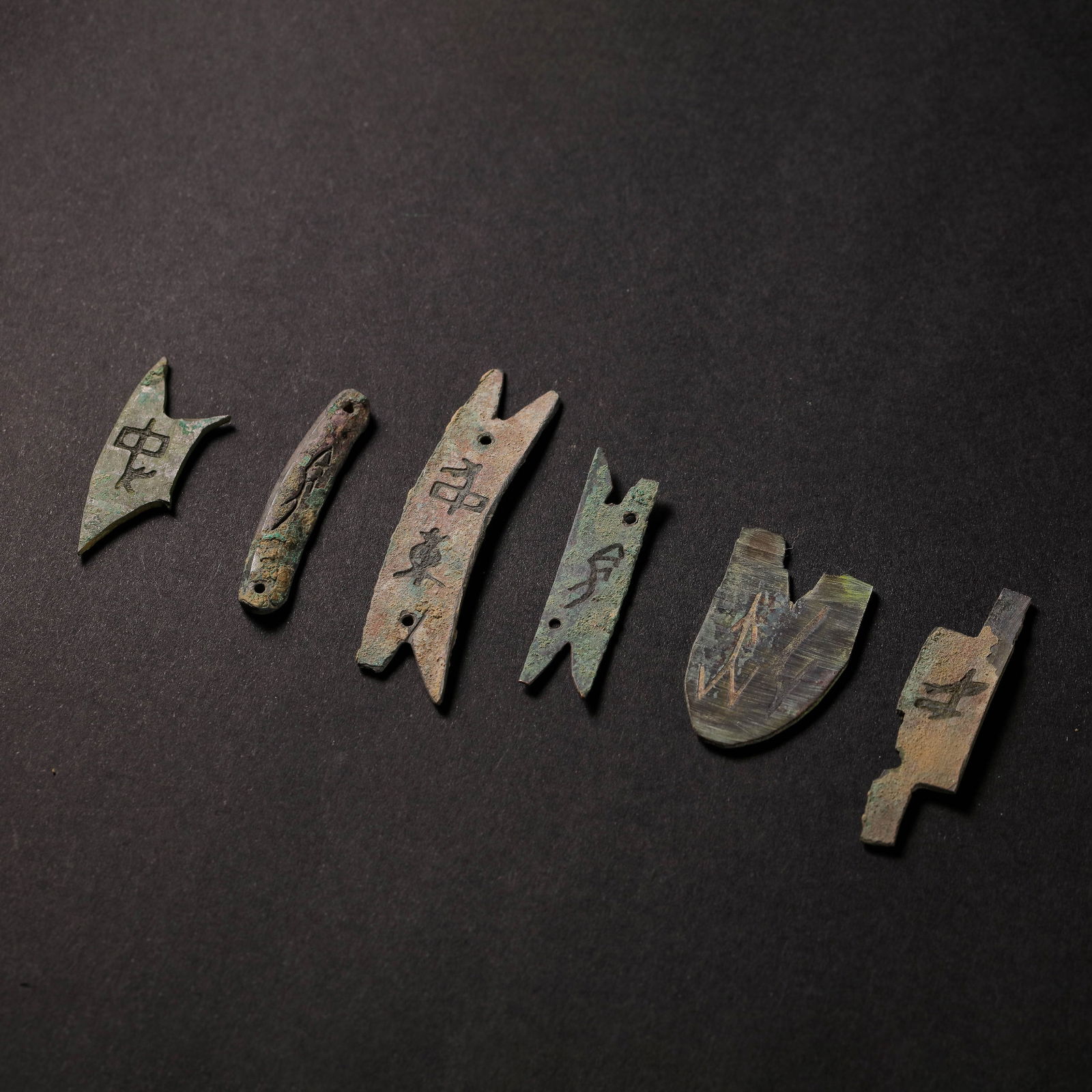 A GROUP OF INSCRIBED BRONZE FRAGMENTS WITH ORACLE BONE SCRIPTLATE SHANG TO EARLY ZHOU DYNASTY (C. (1 of 8)