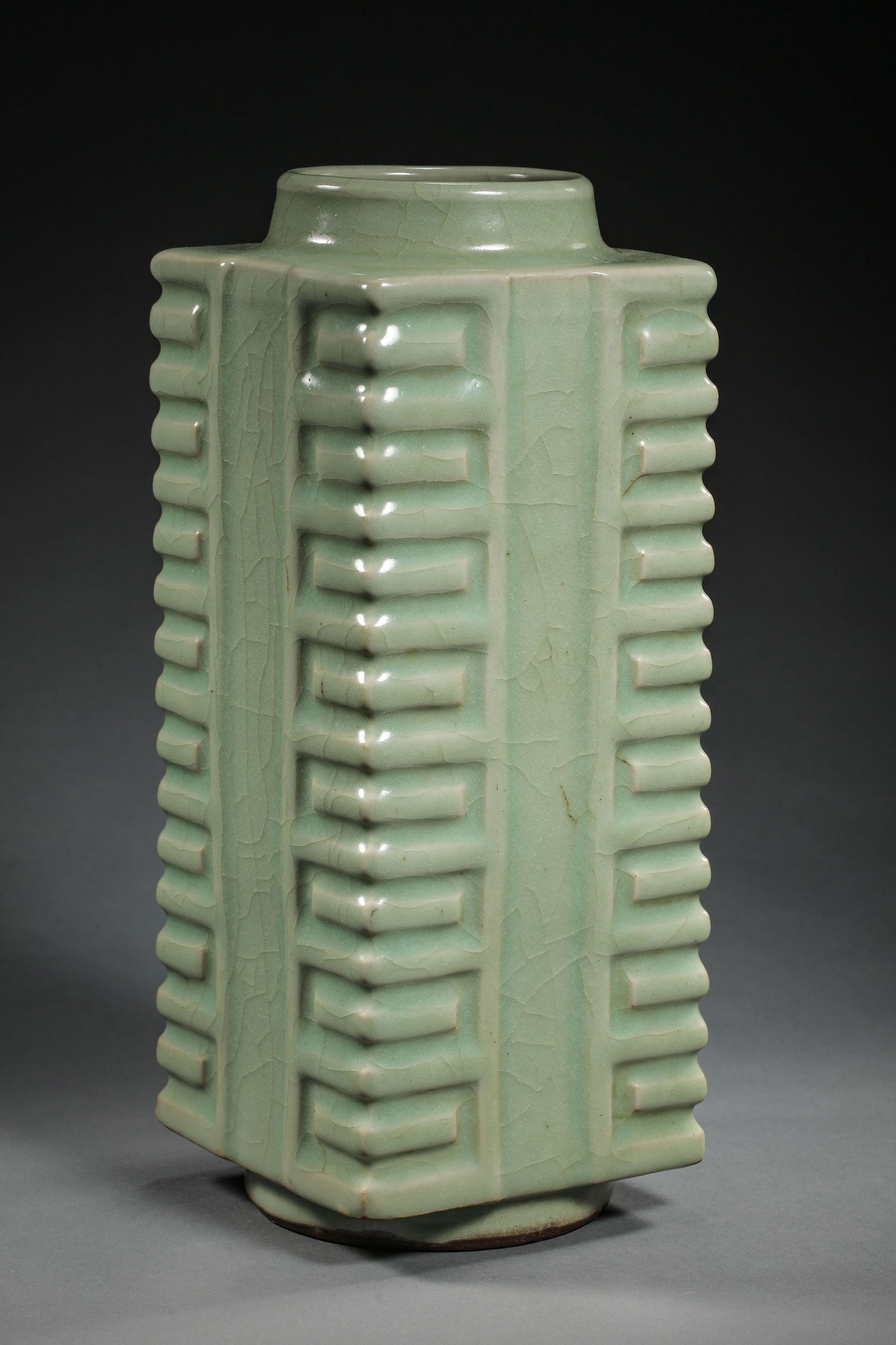 A RARE 'LONGQUAN' CELADON-GLAZED 'CONG-SHAPED' VASESOUTHERN SONG - YUAN DYNASTY (12TH–14TH: The vase is elegantly potted with a square-sectioned body rising from a short circular foot to a tapered neck and circular rim. The form is inspired by the ancient ritual jade cong of the Neolithic pe