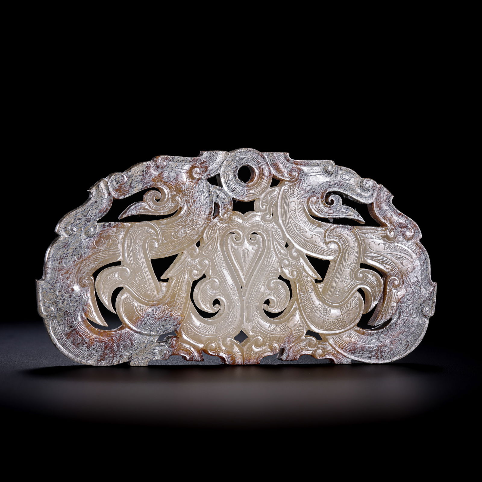 A RARE AND MAGNIFICENT WHITE JADE 'DOUBLE-DRAGON' PENDANT,HUANGWARRING STATES PERIOD (475-221 BC): Description The pendant is masterfully carved from a slender, translucent slab of Hetian white jade, fashioned into an arched or "S-curve" silhouette depicting two dragons conjoined at their tails or