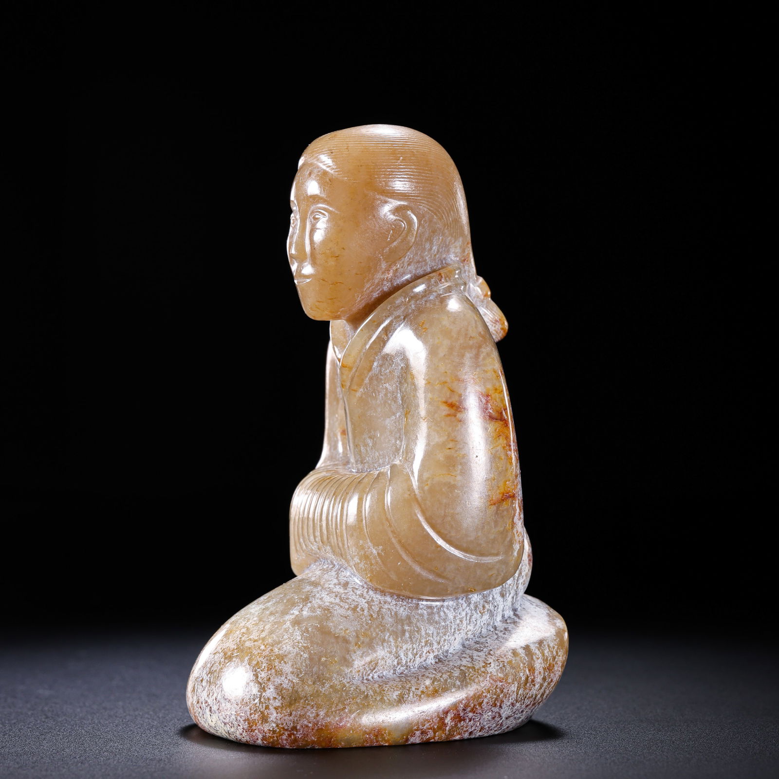 A MAGNIFICENT AND HIGHLY IMPORTANT HETIAN WHITE JADE KNEELING FIGURE,YU GUI RENHAN DYNASTY (206 BC: Description This exceptional figure is masterfully sculpted in the round from a single, substantial block of Hetian white jade (nephrite). It depicts a dignified figure in a formal kneeling position ,