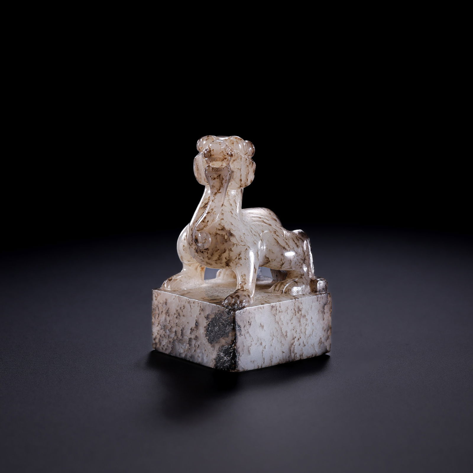 A RARE AND EXQUISITE WHITE JADE 'MYTHICAL BEAST' SEALWARRING STATES PERIOD TO HAN DYNASTY (C. 3RD: Description This rare personal seal is masterfully carved from a single block of Hetian white jade, possessing an unctuous, mutton-fat luster. The stone is distinguished by a profound and rhythmic "me