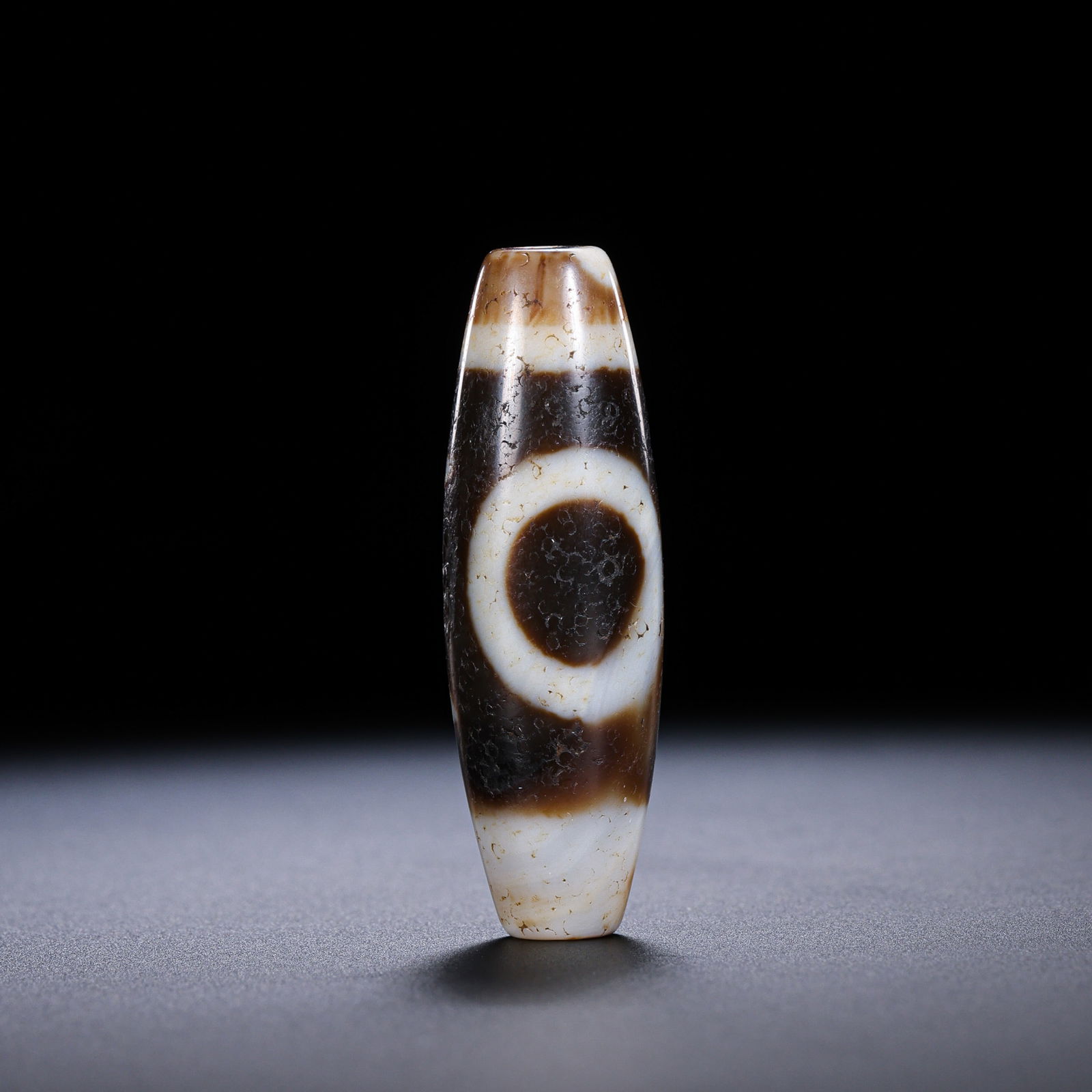 A RARE AND MAGNIFICENT 'SUN AND MOON' DZI BEADHIMALAYAN REGION, TIBET, ANCIENT TO MEDIEVAL PERIOD (1 of 11)