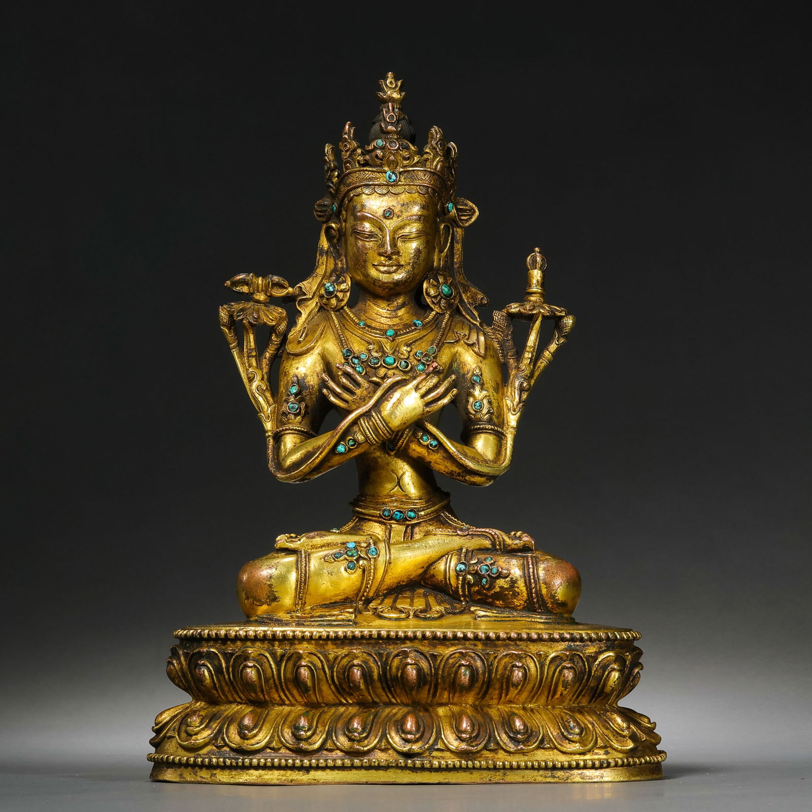 A FINELY CAST GILT-BRONZE FIGURE OF TARATIBET, 15TH - 16TH CENTURY: Description This exquisite figure depicts Tara, the "Mother of Liberation," seated in the elegant posture of lalitasana (royal ease) on a double-lotus pedestal. The right foot is gracefully extended,