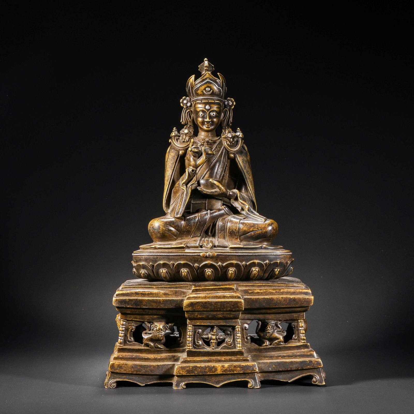 RARE AND MAGNIFICENT ALLOY COPPER FIGURE OF SHAKYAMUNI BUDDHANEPAL OR NORTHEAST INDIA, 12TH - 13TH: Description The figure is masterfully cast in a high-quality alloy copper, depicting Shakyamuni Buddha seated in the meditative vajraparyankasana (full lotus position). The right hand is extended in t