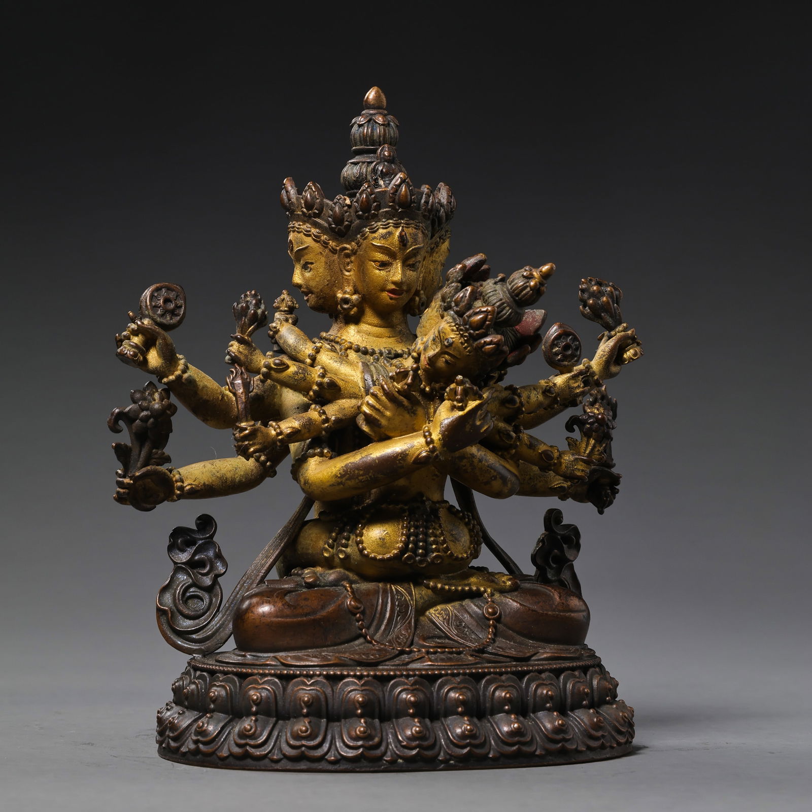 A RARE AND FINELY CAST GILT-BRONZE FIGURE OF A HERUKA AND CONSORT (YAB-YUM)MING - QING DYNASTY, 17TH: DescriptionThe deity is masterfully cast seated in padmasana (lotus position) on a beaded lotus pedestal, depicted in ecstatic embrace with his consort. The main figure is rendered with multiple arms