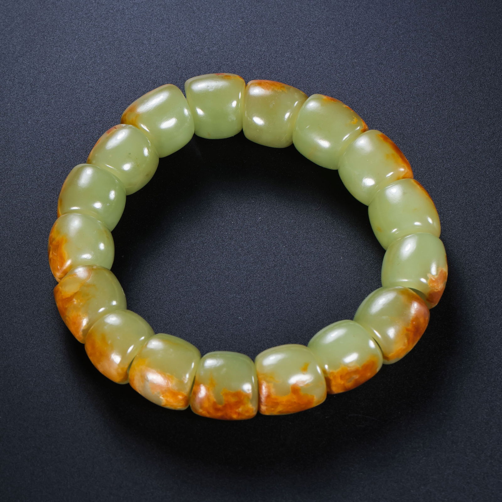 A RARE AND MAGNIFICENT STRAND OF YELLOW JADE BEADSHONGSHAN CULTURE, NEOLITHIC PERIOD (C. 3500-3000: Description The necklace is composed of a series of meticulously fashioned yellowish-celadon jade beads, each exhibiting a soft, waxy luster and a rich amber-toned patina. The beads are of graduated s