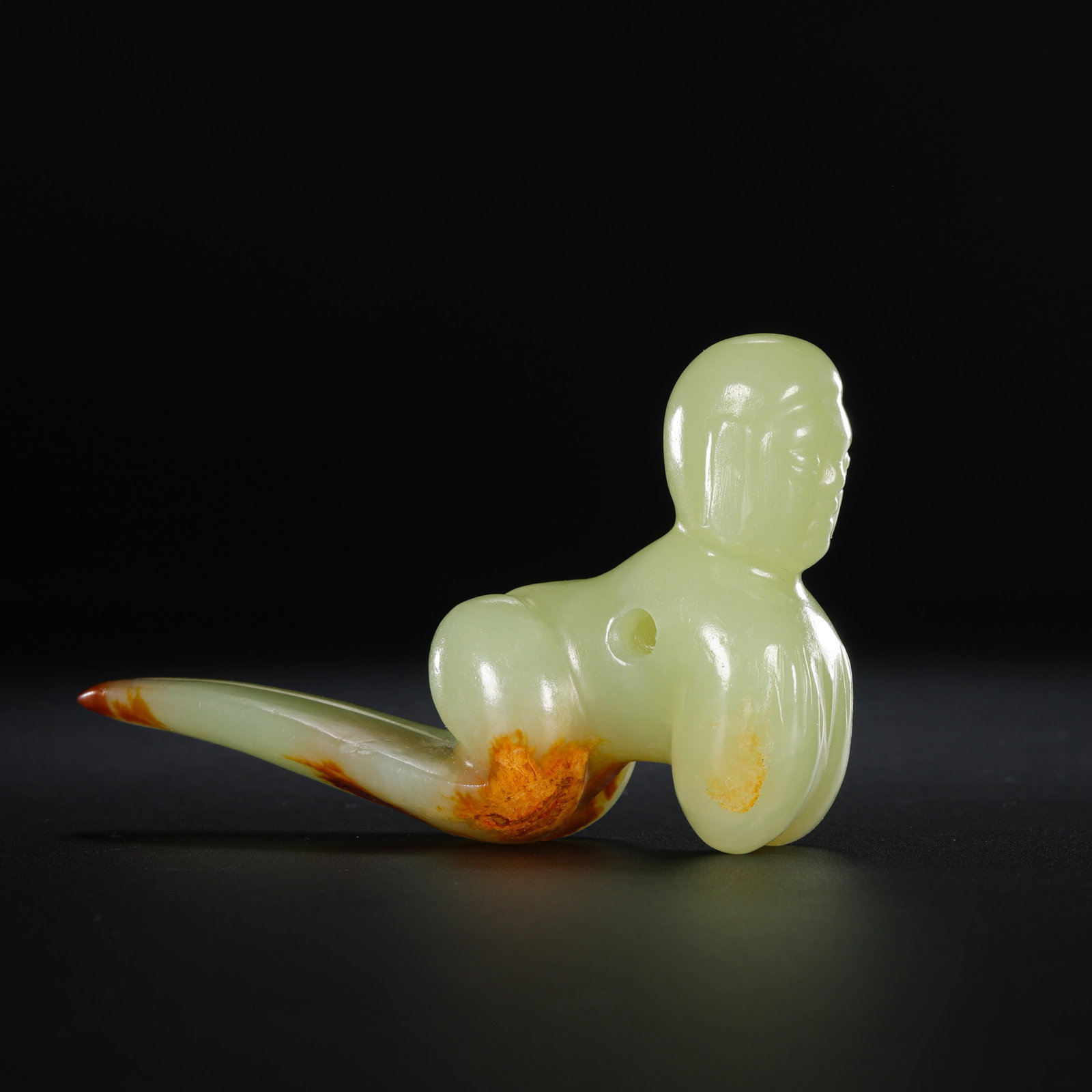 A RARE AND HIGHLY IMPORTANT YELLOW JADE HUMANOID FIGUREHONGSHAN CULTURE, NEOLITHIC PERIOD (C.: DescriptionThe figure is masterfully carved from a translucent yellowish-celadon jade of superb quality. It depicts a stylized humanoid in a characteristic Hongshan meditative or ritualistic posture.