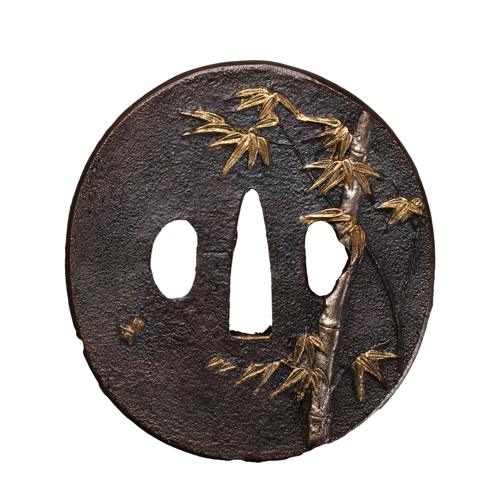 A FINE PARTIALLY GILT IRON 'BAMBOO' TSUBAEDO PERIOD (17TH–19TH CENTURY): Description This elegantly crafted Tsuba (Sword Guard) is a superb example of the decorative metalwork that flourished during the peaceful Edo period. The piece is characterized by its robust construc