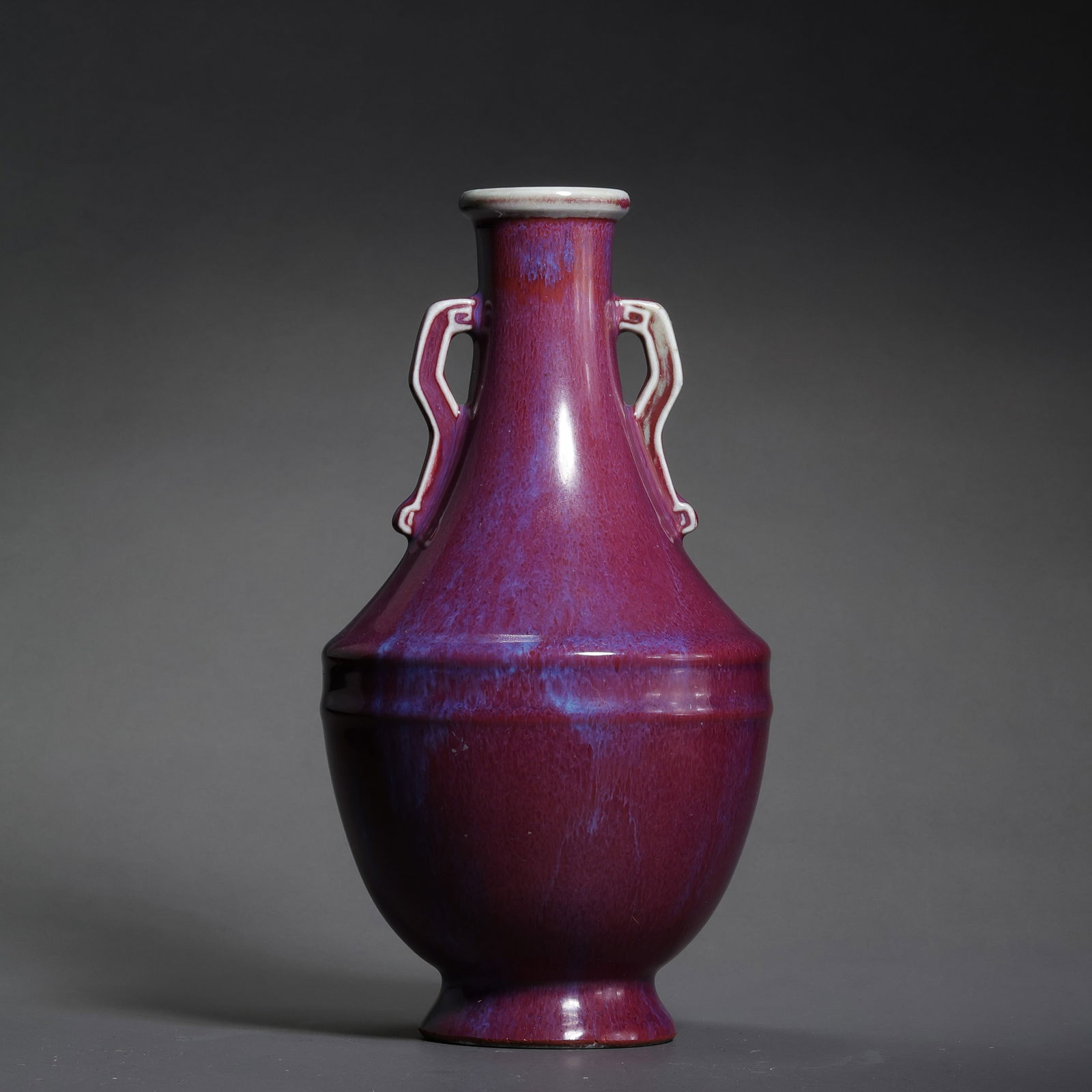 A RARE AND MAGNIFICENT FLAMBÉ-GLAZED 'PIGEON-EAR' VASESEAL MARK AND PERIOD OF QIANLONG: "Description The vase is elegantly potted with a pear-shaped body supported by a short, slightly flared foot, rising to a waisted neck and a flared rim. It is flanked by a pair of stylized 'pigeon-ear