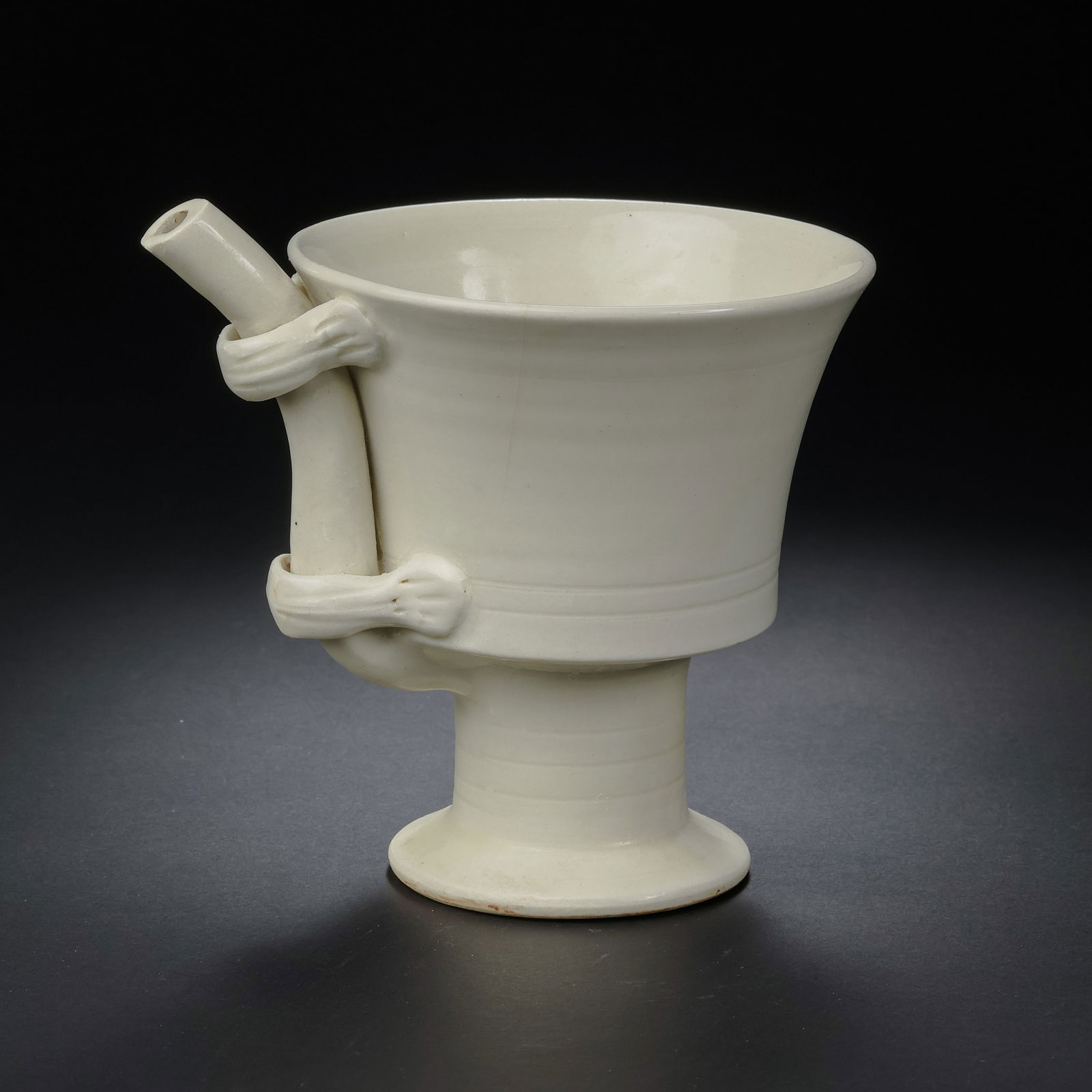 A MAGNIFICENT AND HIGHLY RARE WHITE-GLAZED 'TURTLE' SIPHON CUPDING WARE, NORTHERN SONG DYNASTY: Description This exceptional vessel is a masterpiece of Northern Song ceramic ingenuity, originating from the illustrious Ding kilns of Hebei province. The cup is designed with a deep, rounded bowl re