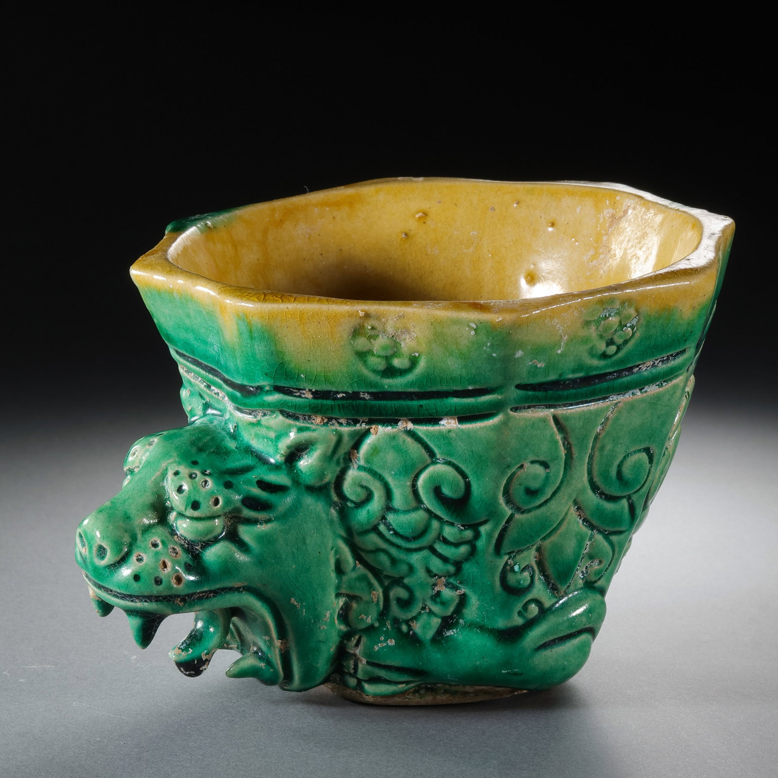 Yellow-green glazed animal-head cup from the Tang Dynasty, China: H. 8.3 cm. W. 11.2 cm.