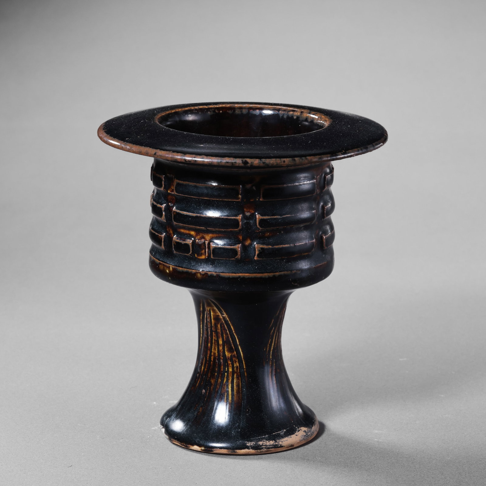 A tall, footed incense burner with black glaze and octagonal design from the Cizhou kiln of the: Diam. 12 cm. H. 13.5 cm.