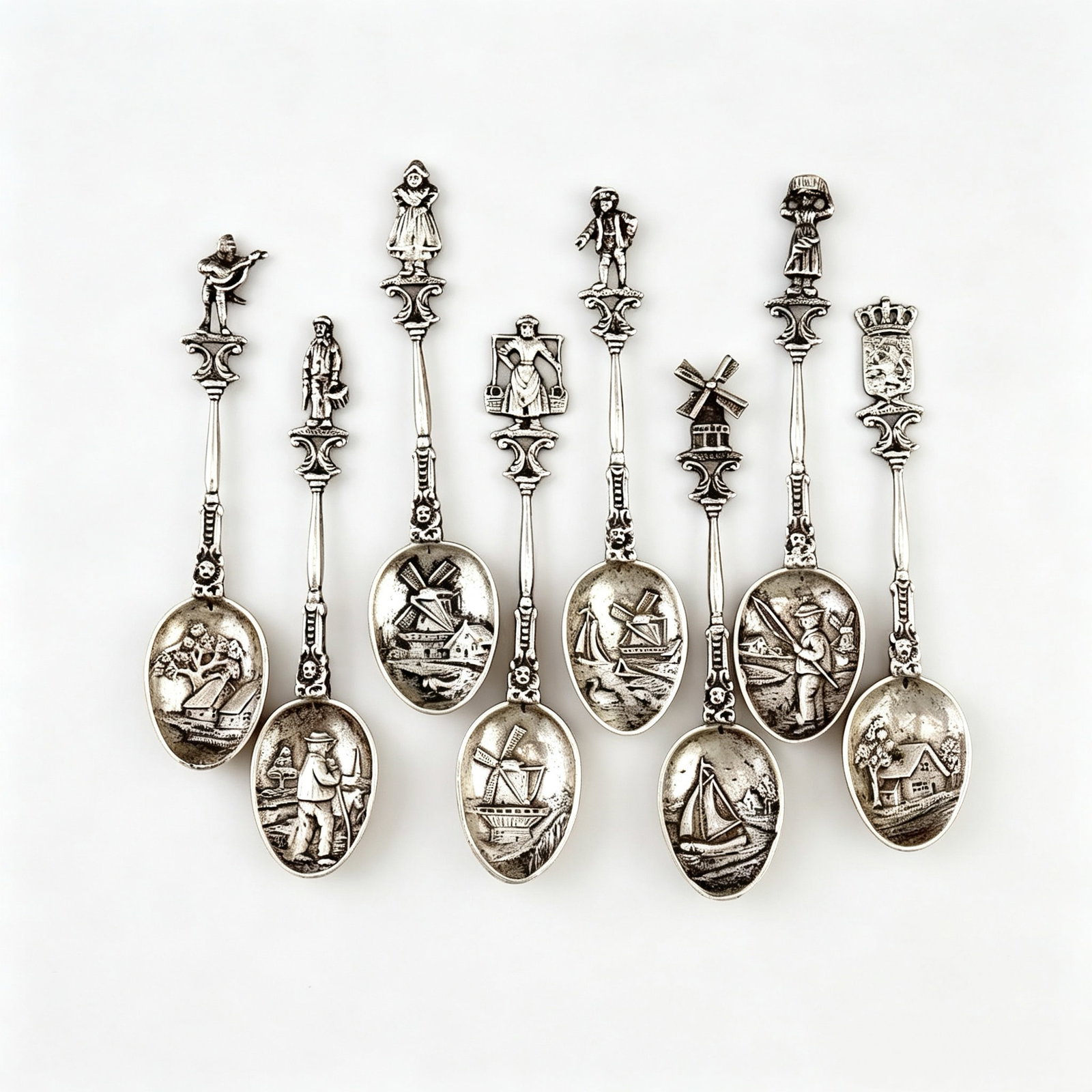 Set of Dutch Folk Relief Solid Silver Souvenir Spoons, Late 19th – Early 20th Century Antique: Recommended DateCrafted by domestic Dutch silversmith workshops circa 1900Weight & DimensionsTotal net weight of the full set: 92.5 gramsOverall length of single spoon: 3.94 inMaterial DescriptionEver