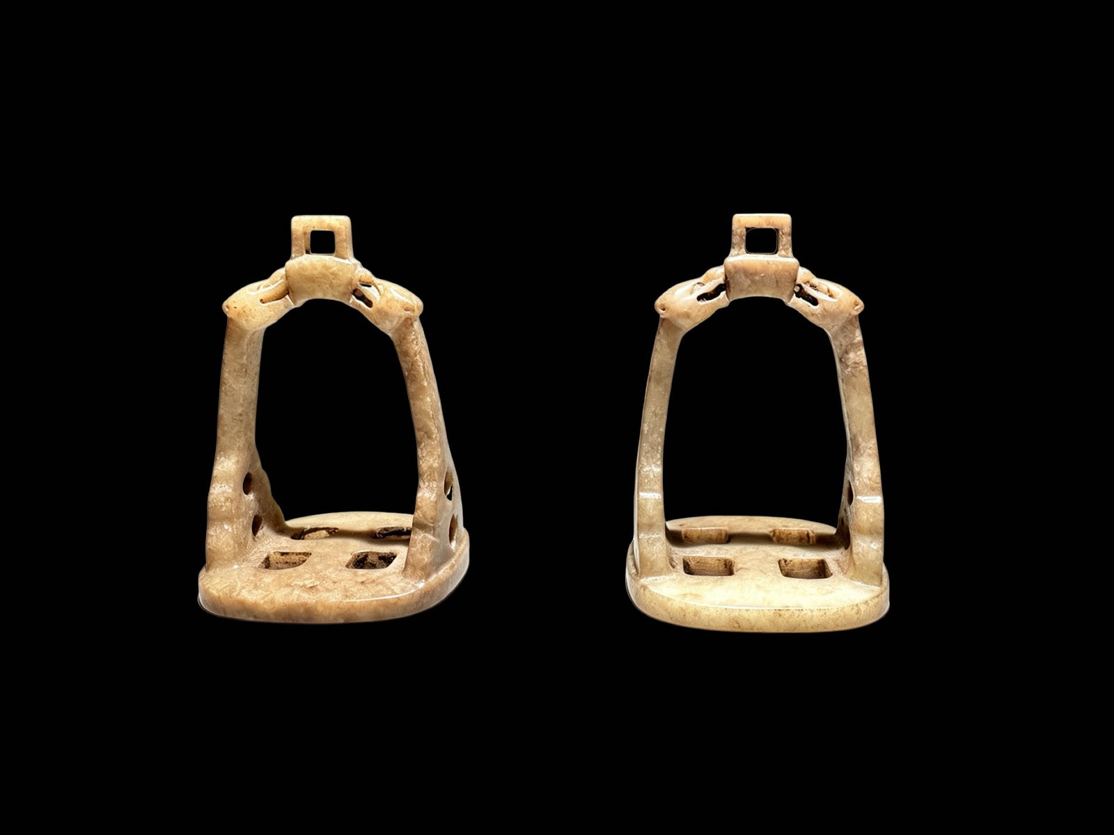 Pair of Jade Stirrup Ornaments (Chariot & Horse Decorative Fittings): Material: Nephrite jade. The pair is entirely enveloped by an even beige-brown secondary patina, with pale bluish-white as the original jade base tone. Patina permeates inward along the stone’s