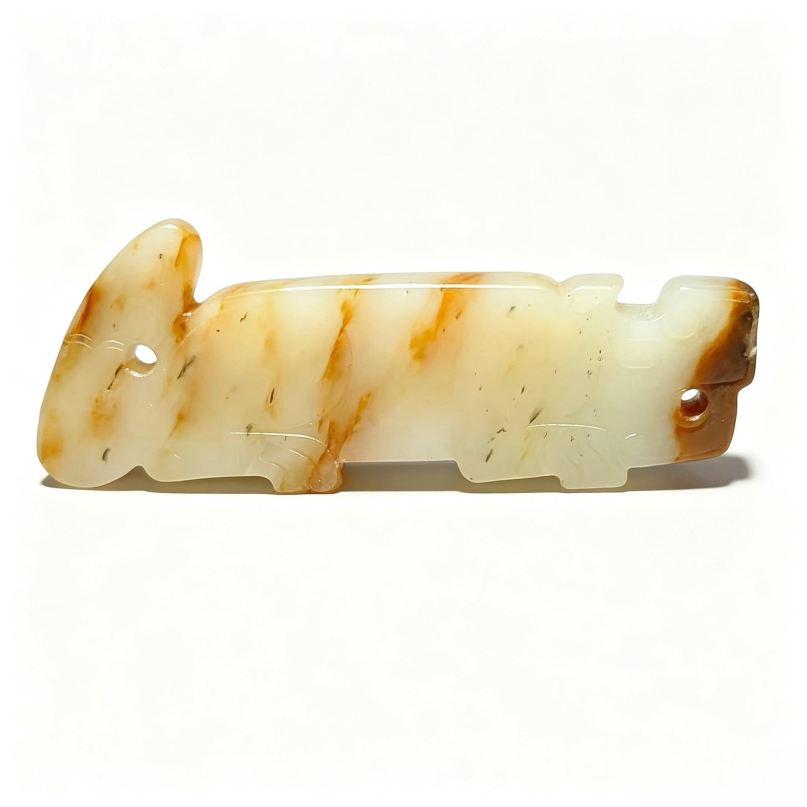 Western Zhou Hetian Seed Jade Tiger-Shaped Pendant: Proposed Date: Tiger-shaped jade pendant of the Western Zhou DynastyDimensions: Length 8.3 cm (3.27 inches), width 2.7 cm (1.06 inches); a flat slab pendant carved from a single piece of jade into a t