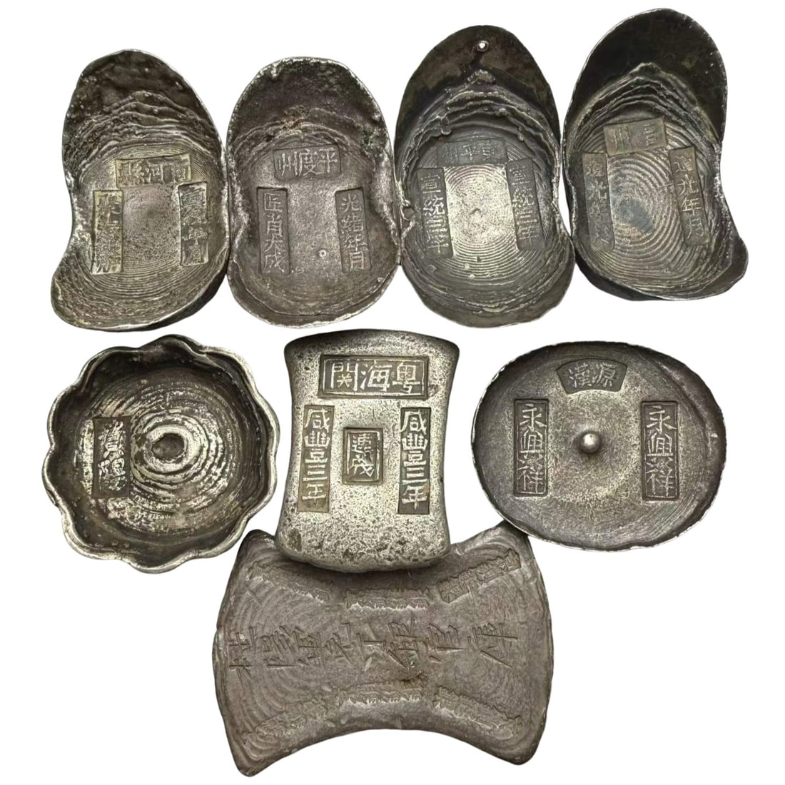 A Set of Eight Ten-Tael Official Silver Ingots of Diverse Shapes, Qing Dynasty (1 of 3)