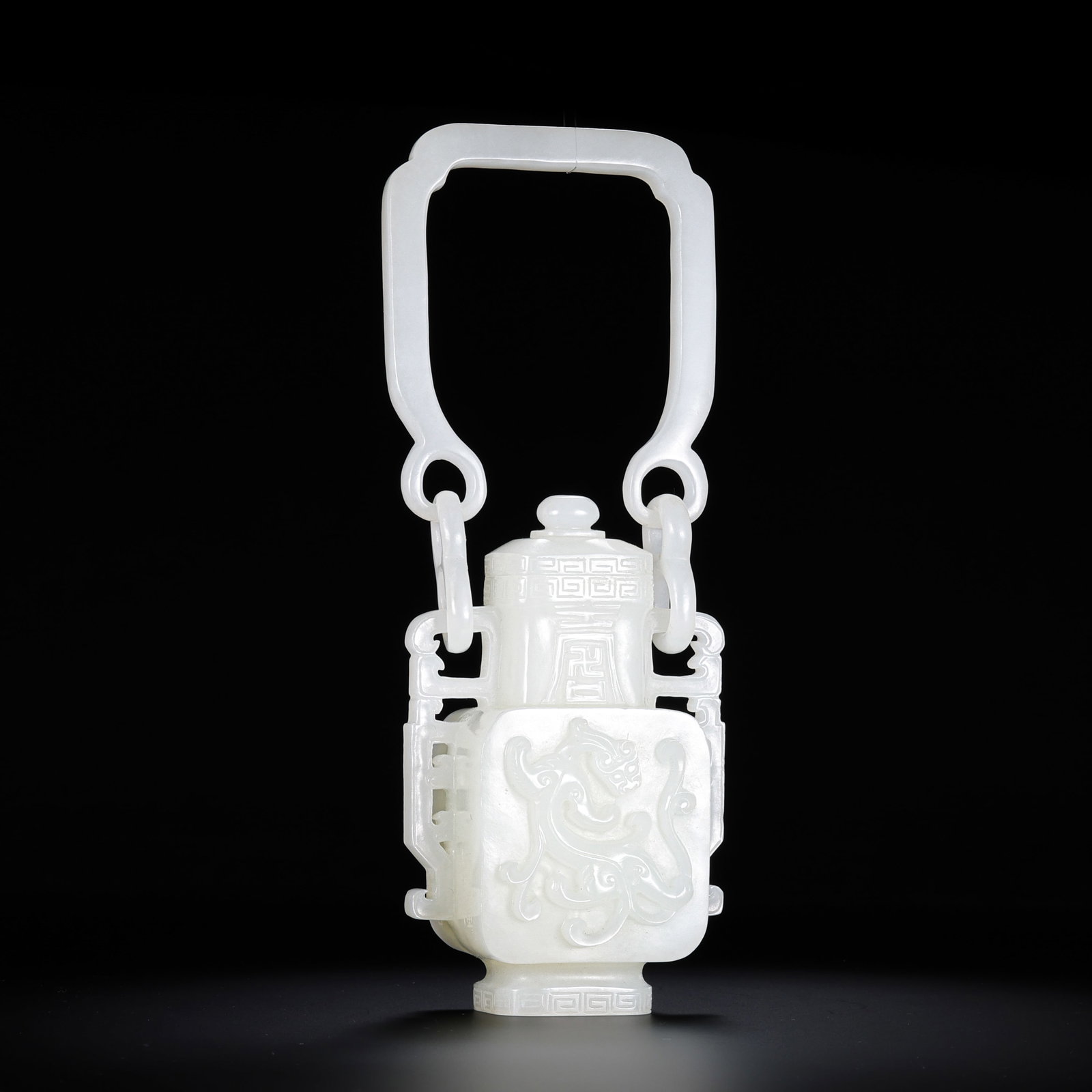Chinese Qing Dynasty Hetian white jade vase with dragon design and handle.: H . 17.5 cm . L . 6.5 cm . Weight 312 gram .