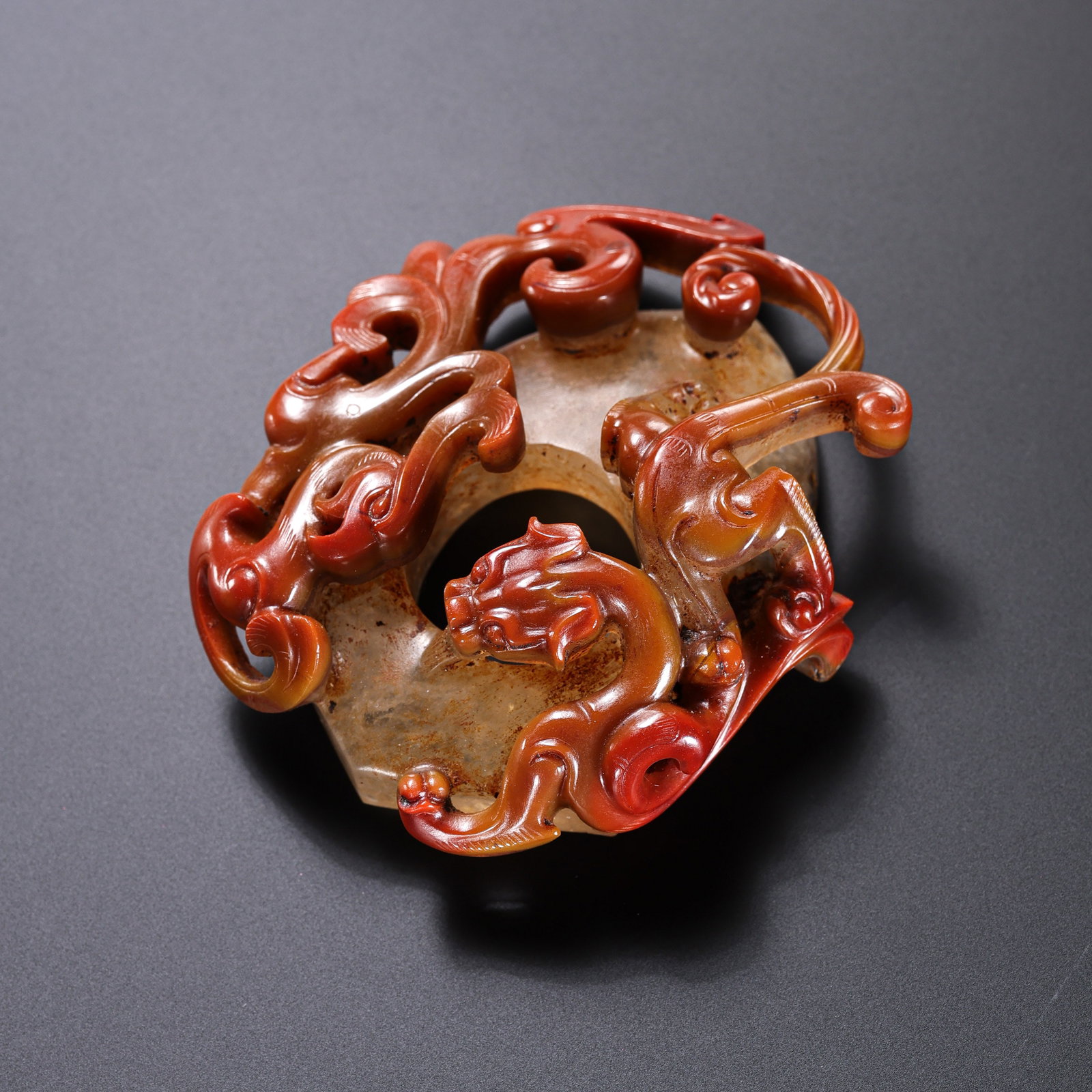 Red agate dragon and phoenix patterned chicken heart pendant from the Warring States period of China: Diam . 6.6 cm .
