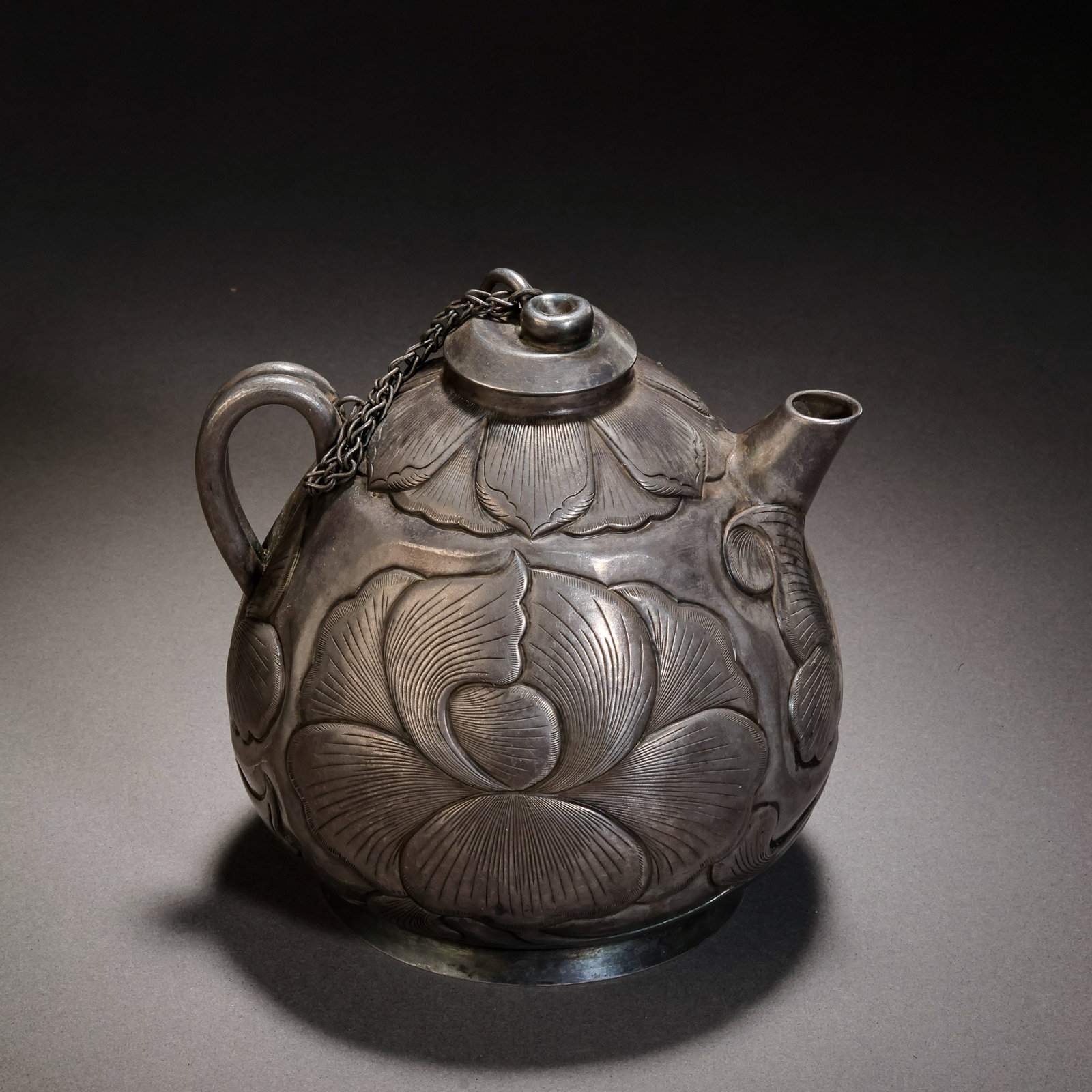 A pure silver lotus petal patterned ewer from the late Tang and Five Dynasties period in China: H . 12 cm . L . 11.5 cm . Weight 208 gram .