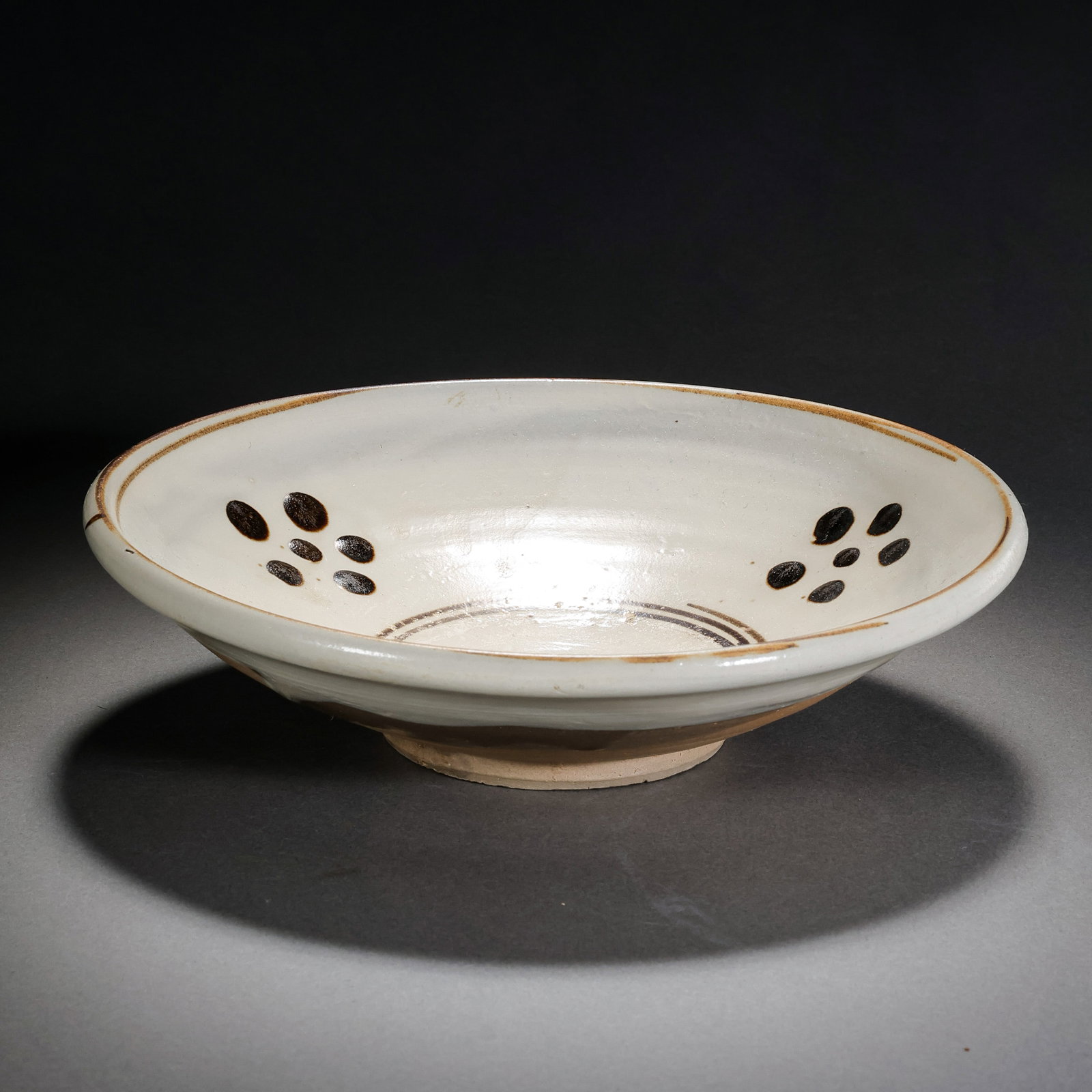 White-glazed plum blossom plate from Cizhou ware, Northern Song Dynasty, China: H . 4.6 cm . Diam . 17.7 cm .