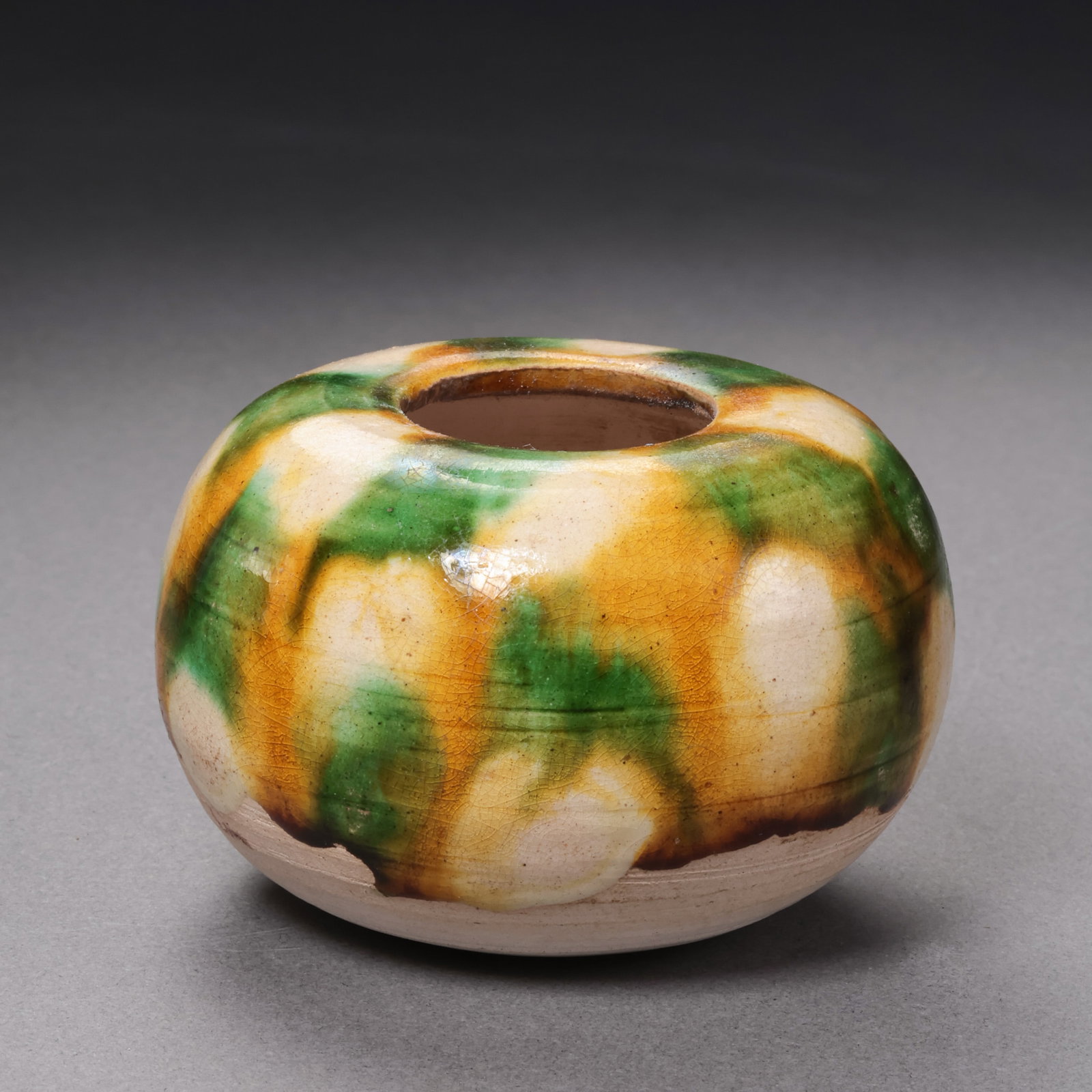 Chinese Tang Dynasty Tricolor Glazed Water Vessel: H. 3.8 cm. W. 6 cm.