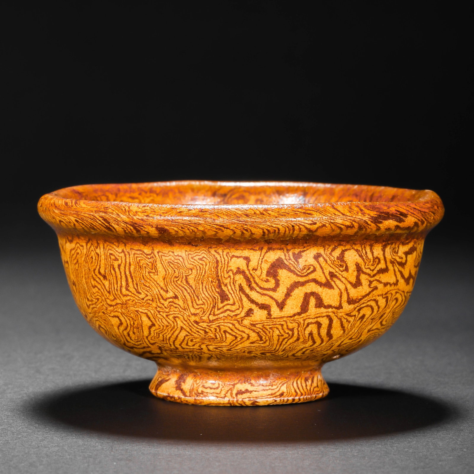 Small yellow-glazed marbled teacup from the Tang Dynasty, China: Diam. 7 cm. H. 3.5 cm.