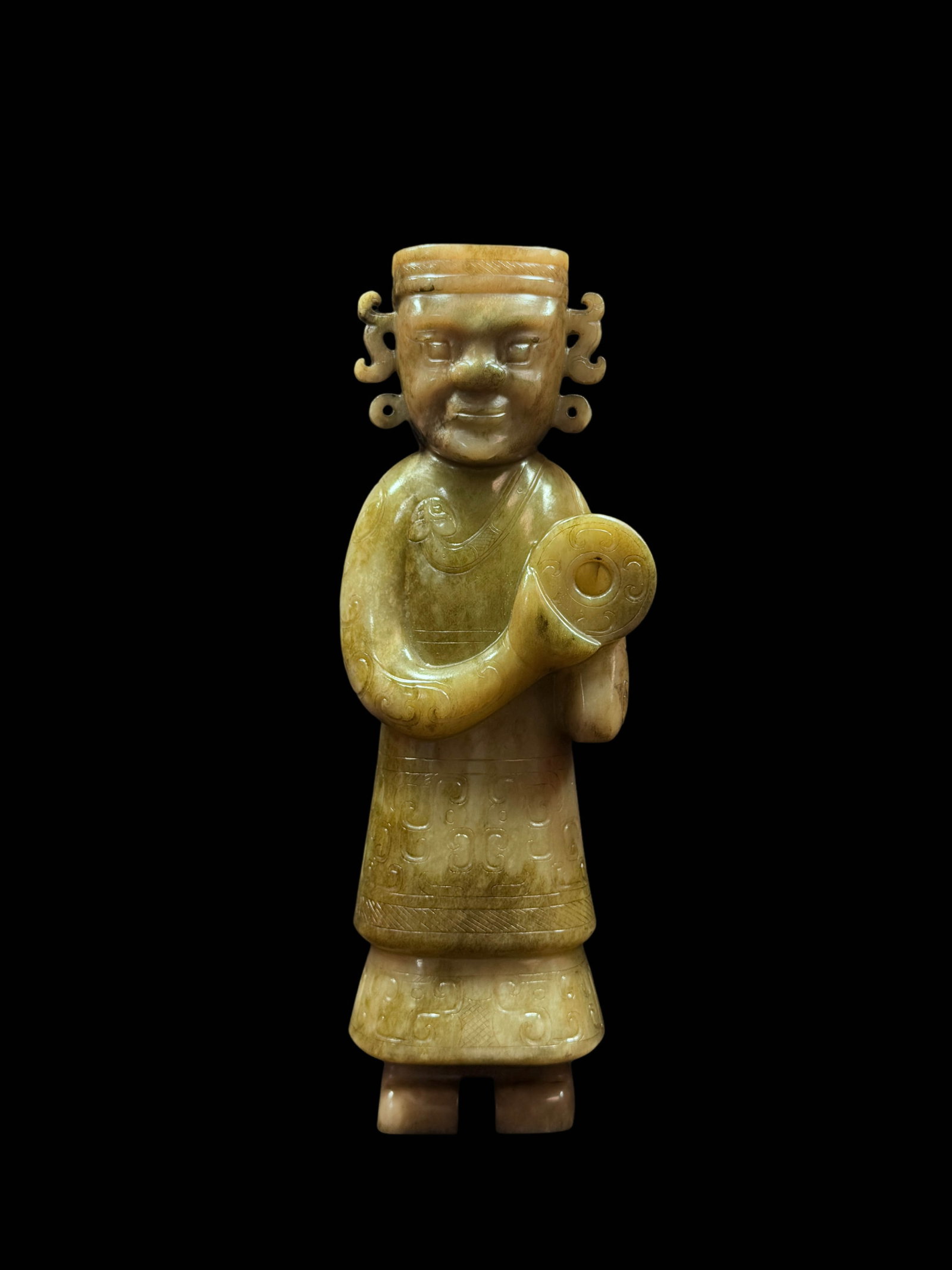 Standing Jade Ritual?Figure Holding a Bi?Disc: Standing Jade Ritual?Figure Holding a Bi?DiscProposed Period: Shang?Zhou DynastyBasic ArchiveDimensions: Height 9.84 in, Width 3.66 in, Thickness 2.36 in; Weight 1973?gCondition: No fractures, no