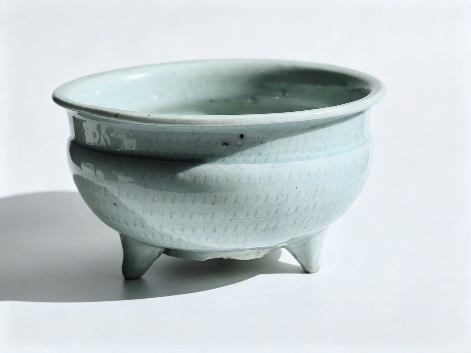 Song-Yuan Hutian Kiln Yingqing Censer with Incised Linear Pattern and Three Legs: DimensionsMouth diameter of 14 cm (5.51 inches) and total height of 8 cm (3.15 inches).Moderately sized, it served as an elegant incense burner for scholar’s studios and ancestral halls throughout