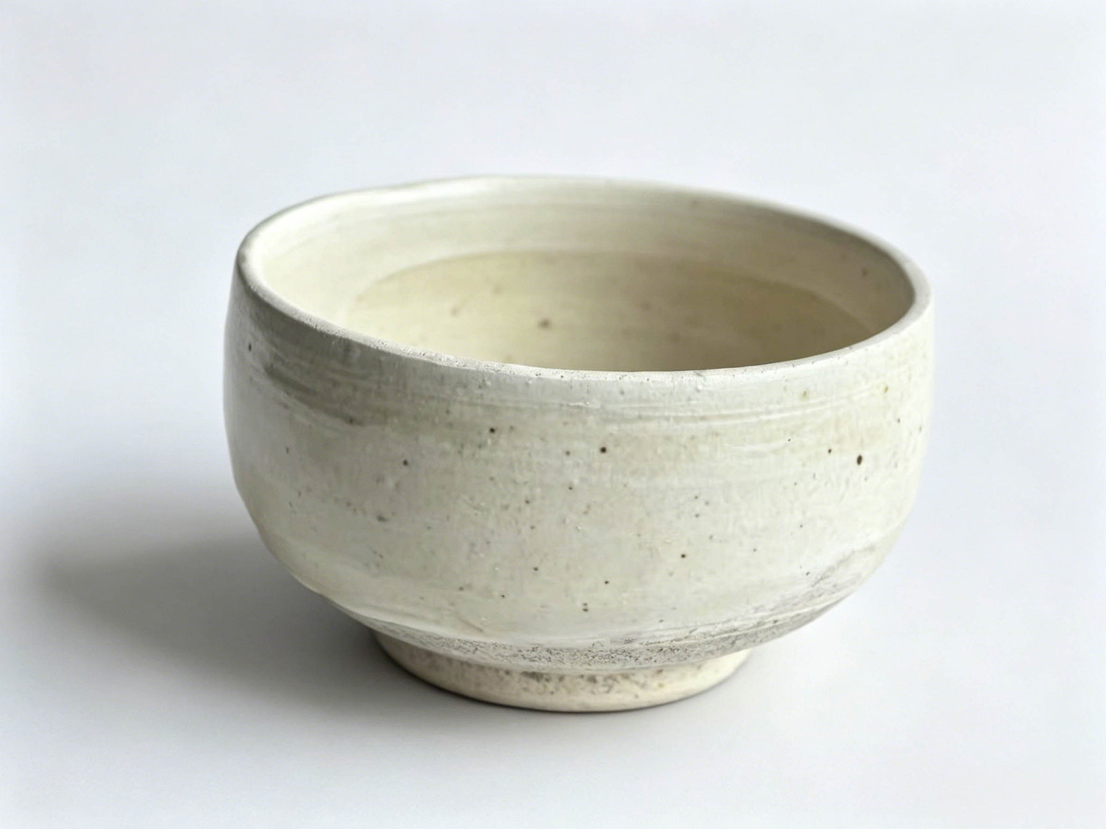 Song-Jin Jingxing Kiln White Glaze Bowl-Style Tea Cup: This is a classic white-glazed bowl-shaped cup from Jingxing Kiln of the Song and Jin dynasties, with a mouth diameter of 8.8 cm and height of 5.3 cm. Compact and rounded, it served as a popular tea