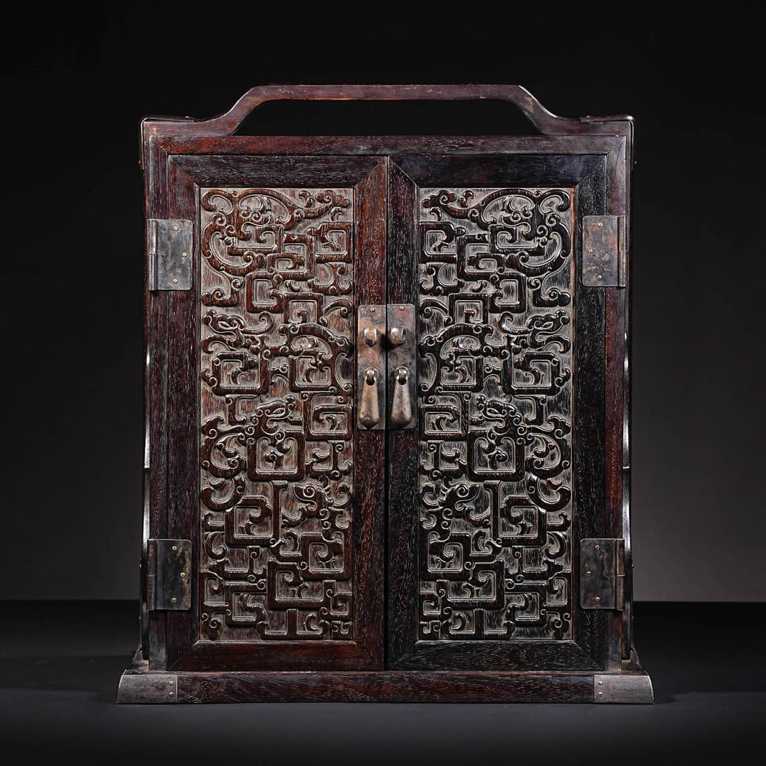 Zitan Wood Treasure Casket with Carved Kui?Dragon Motifs and Carrying Handle: Zitan Wood Treasure Casket with Carved Kui?Dragon Motifs and Carrying HandleSuggested Date: Qing DynastyBasic ArchiveDimensions: Height 40?cm (15.75?in), Width 34?cm (13.39?in); Weight